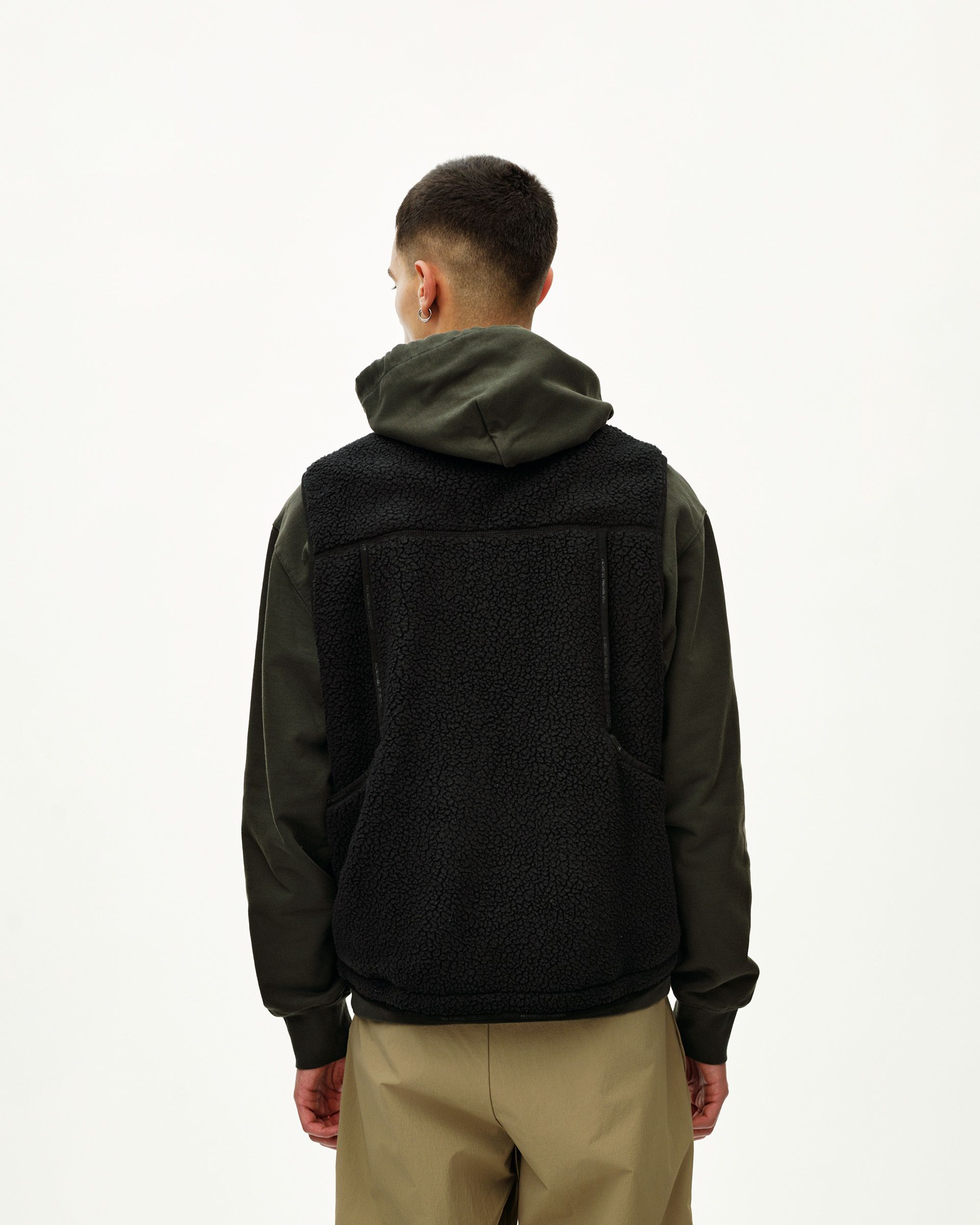 Black Off-Race Pile Fleece Vest on model, rear view with textured sherpa back panel