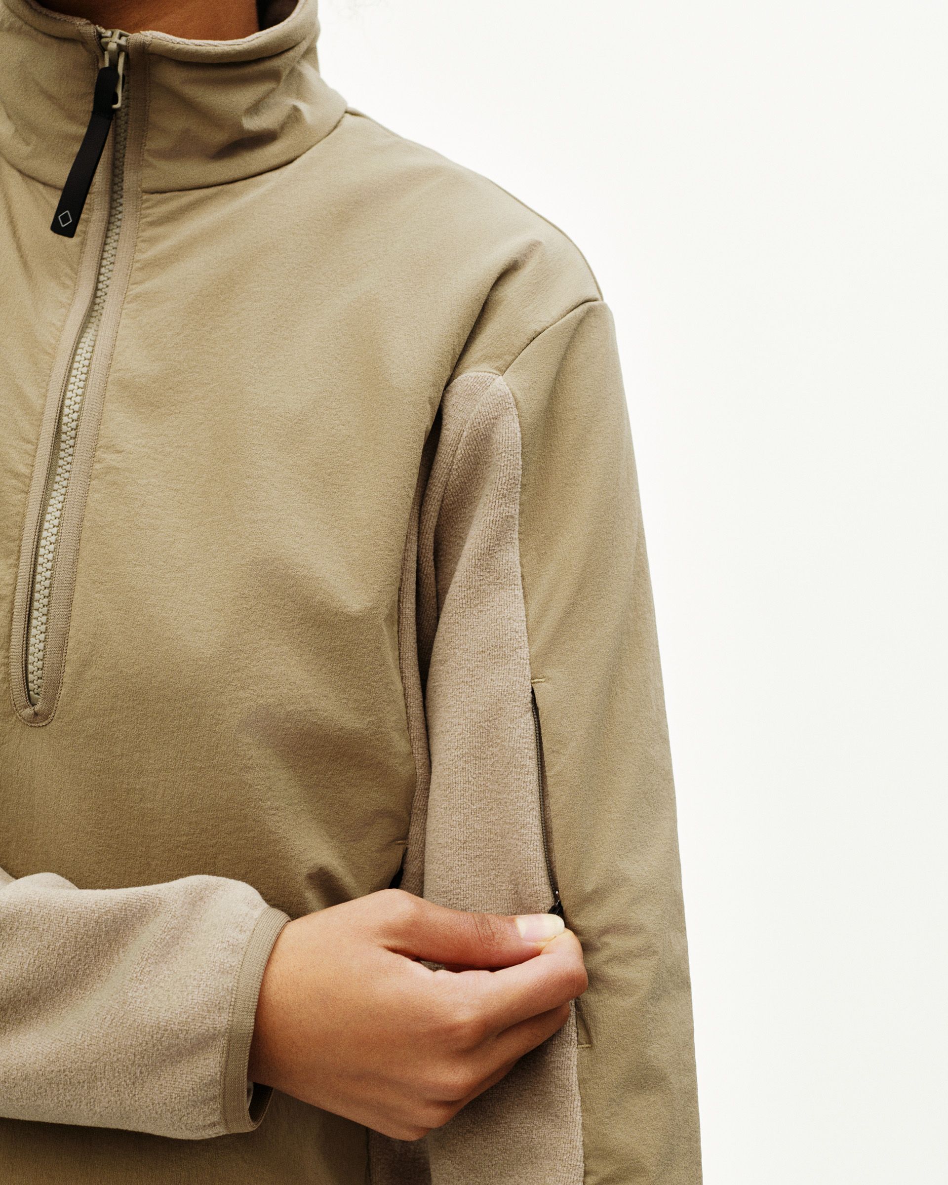 Beige Off-Race Light Fleece half-zip on model with ribbed sleeves and contrast zip