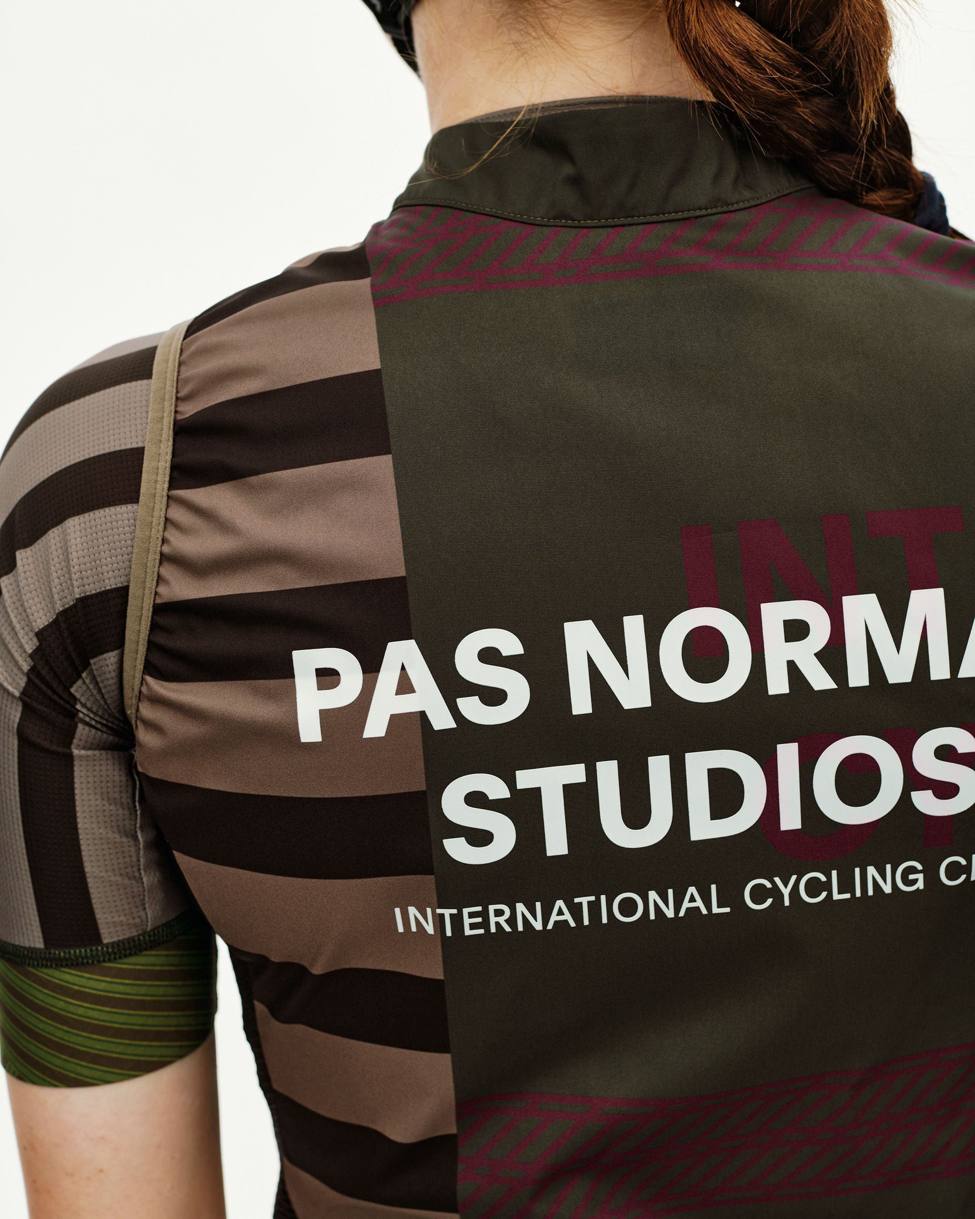 International Earth khaki Mechanism Stow Away women's cycling gilet, rear detail on model with back print and stripe side