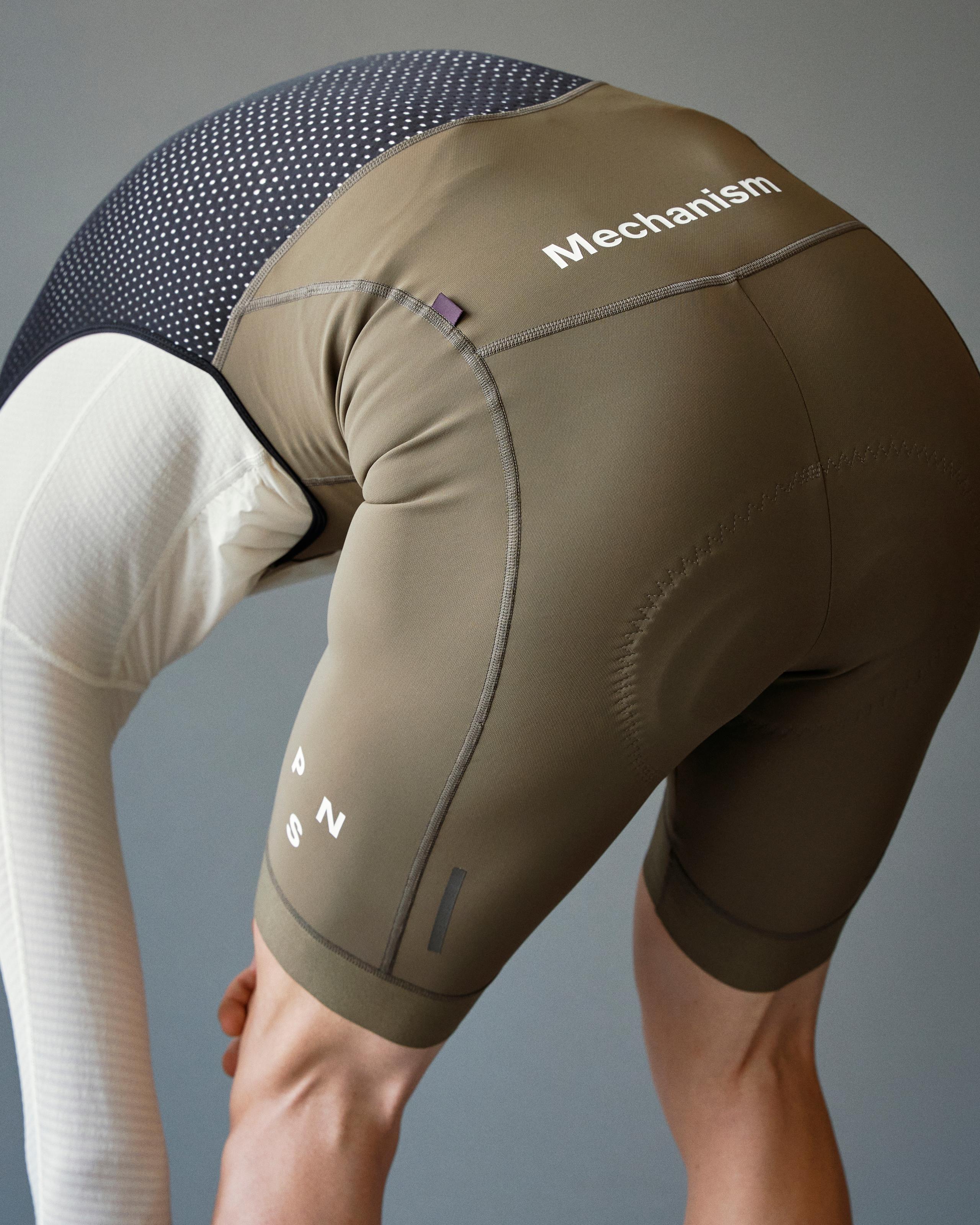 Dark Stone Mechanism Deep Winter cycling bibs on model, rear view with white Mechanism branding