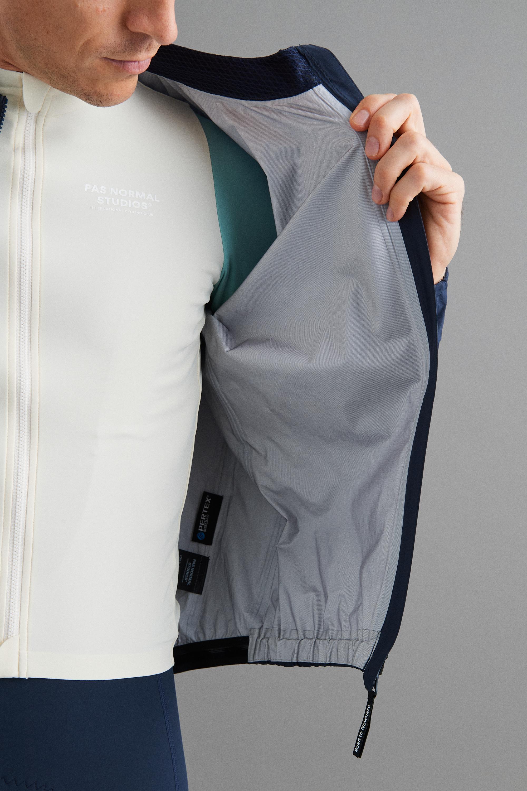 Navy Mechanism Pertex Rain cycling jacket on model showing grey interior lining