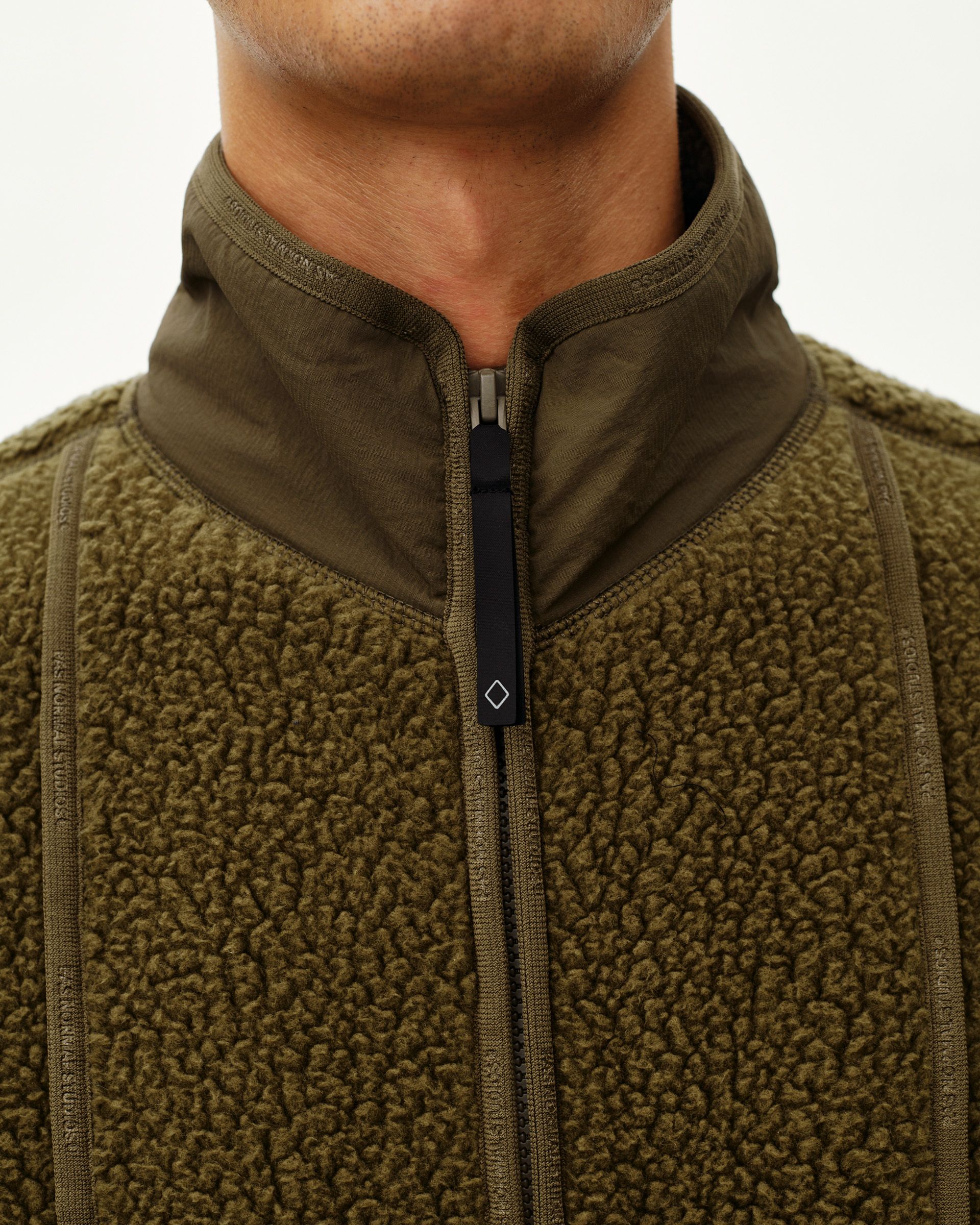 Deep Olive Off-Race Pile Fleece jacket, front detail on model with contrast nylon yoke and center zip