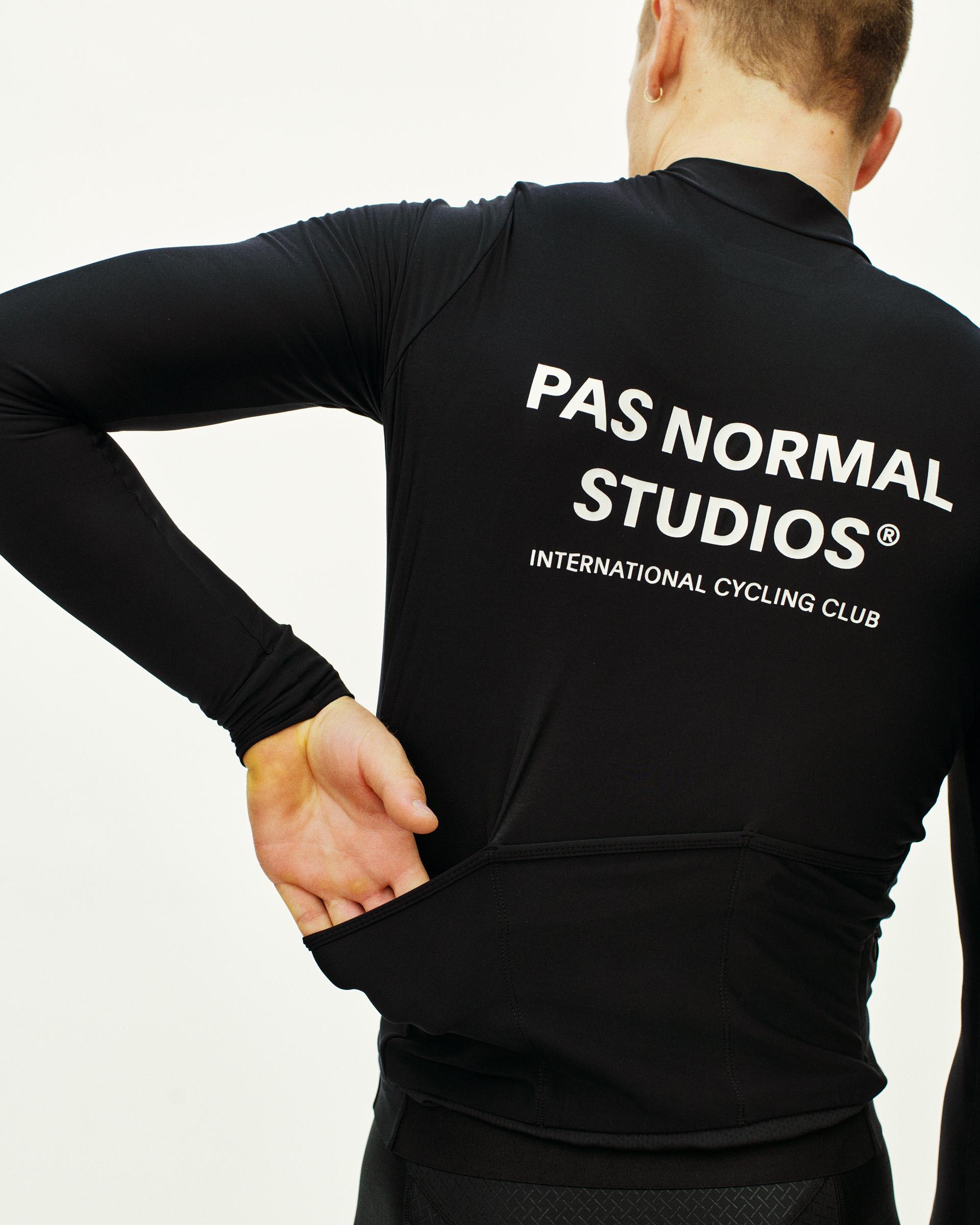 Black Mechanism long sleeve cycling jersey on model, rear view with white back print