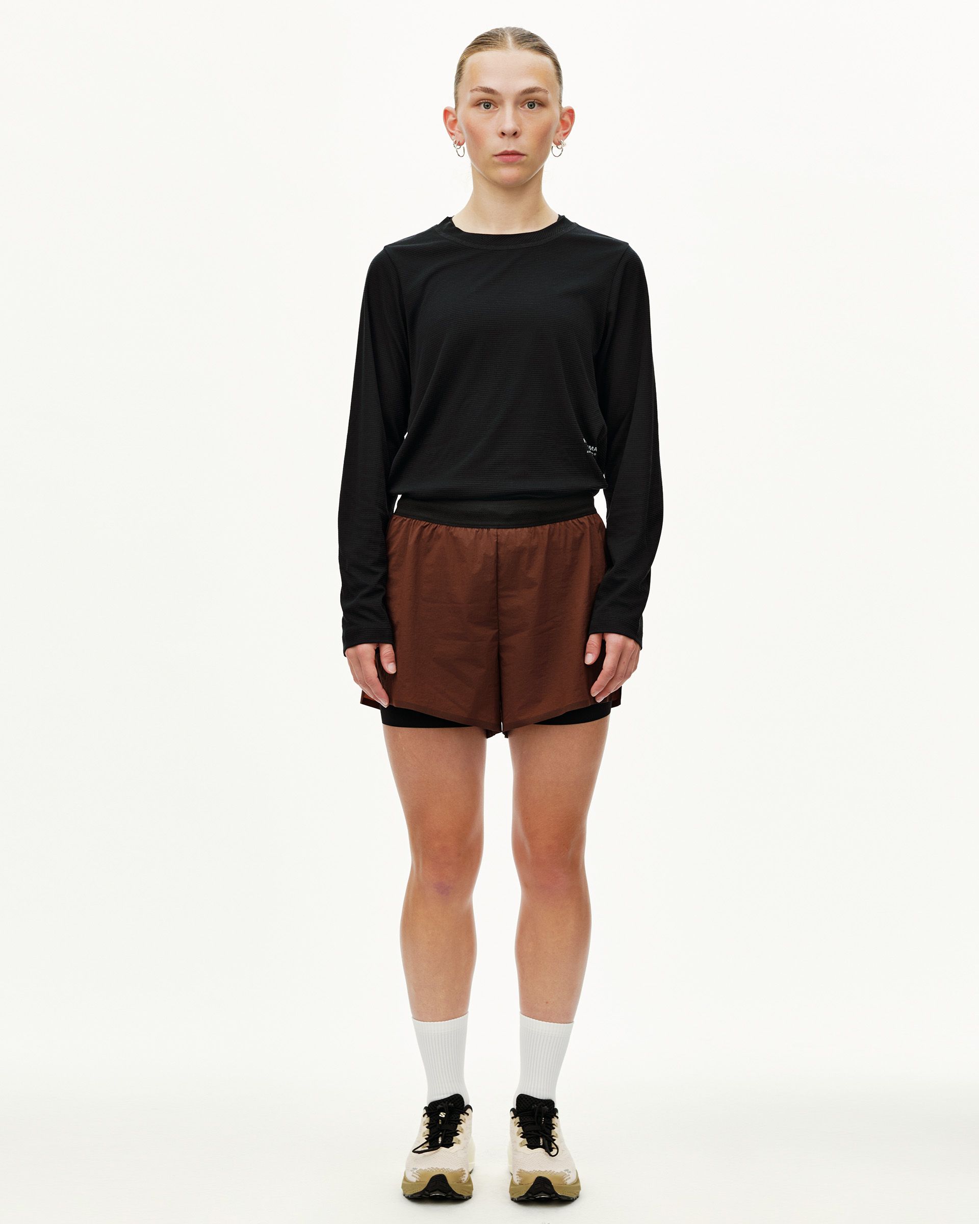 Maroon Brown Balance 2-in-1 shorts on model, front view with black elastic waistband and inner liner