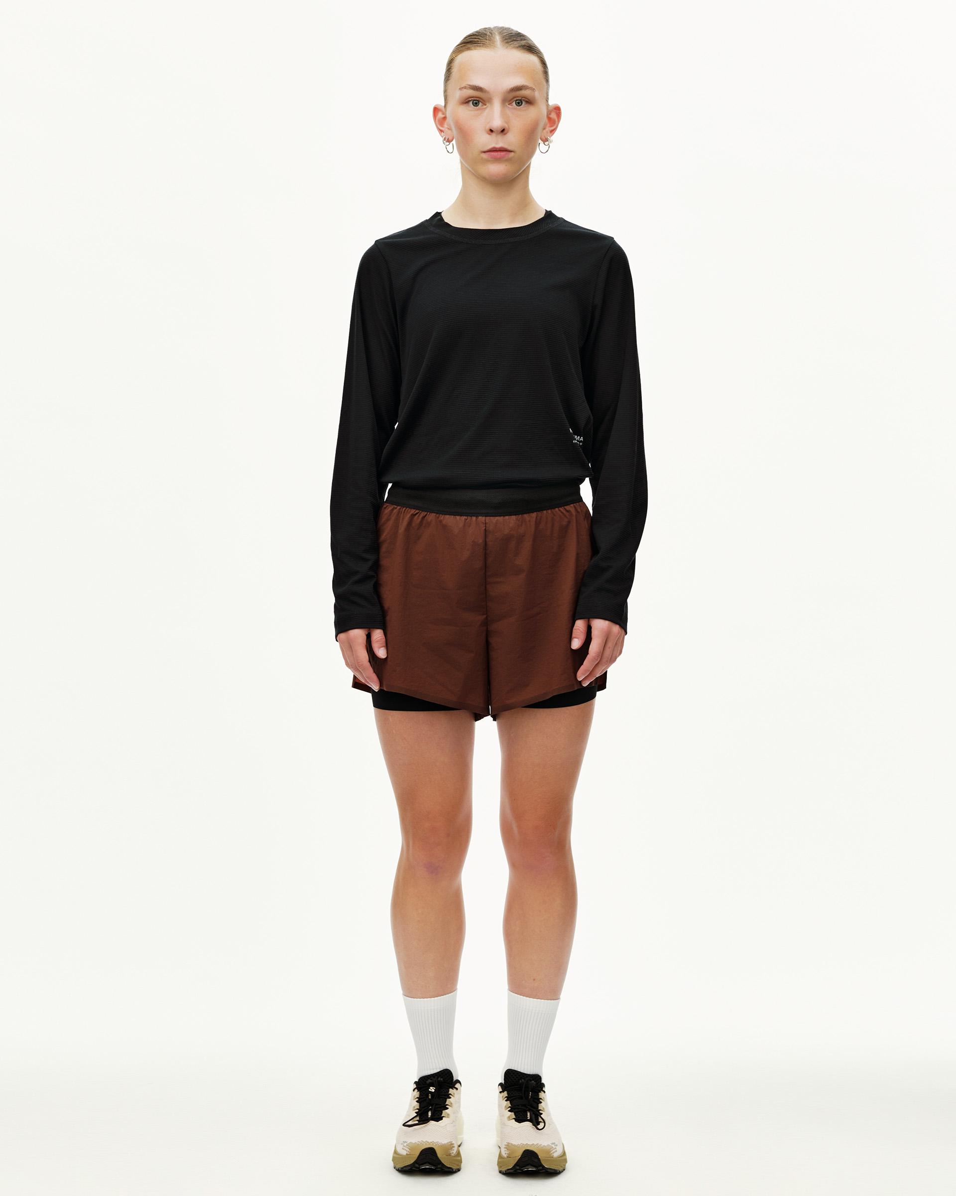 Maroon Brown Balance 2-in-1 shorts on model, front view with black elastic waistband and inner liner