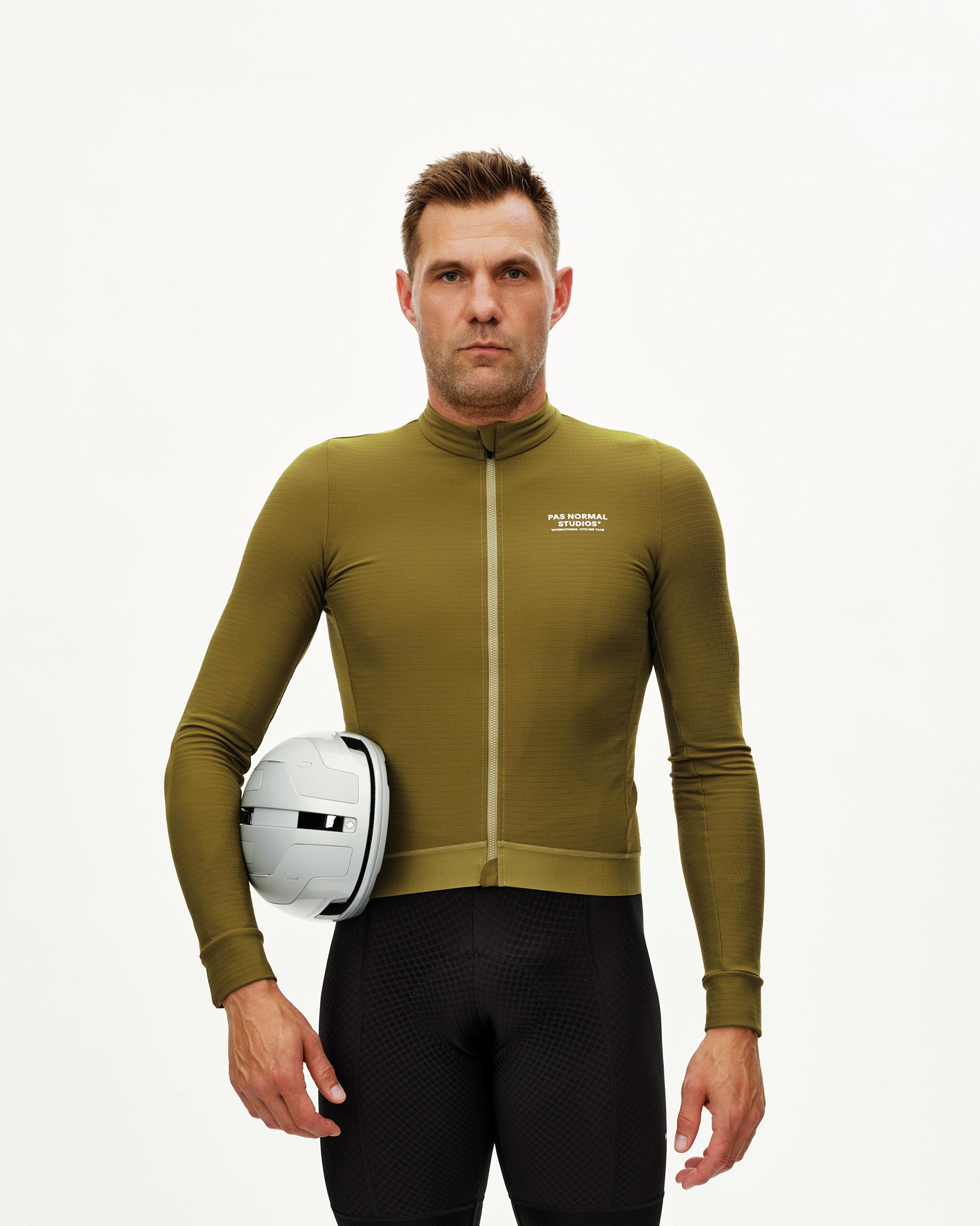 Khaki Green Essential long sleeve cycling jersey on model, front view with chest logo print