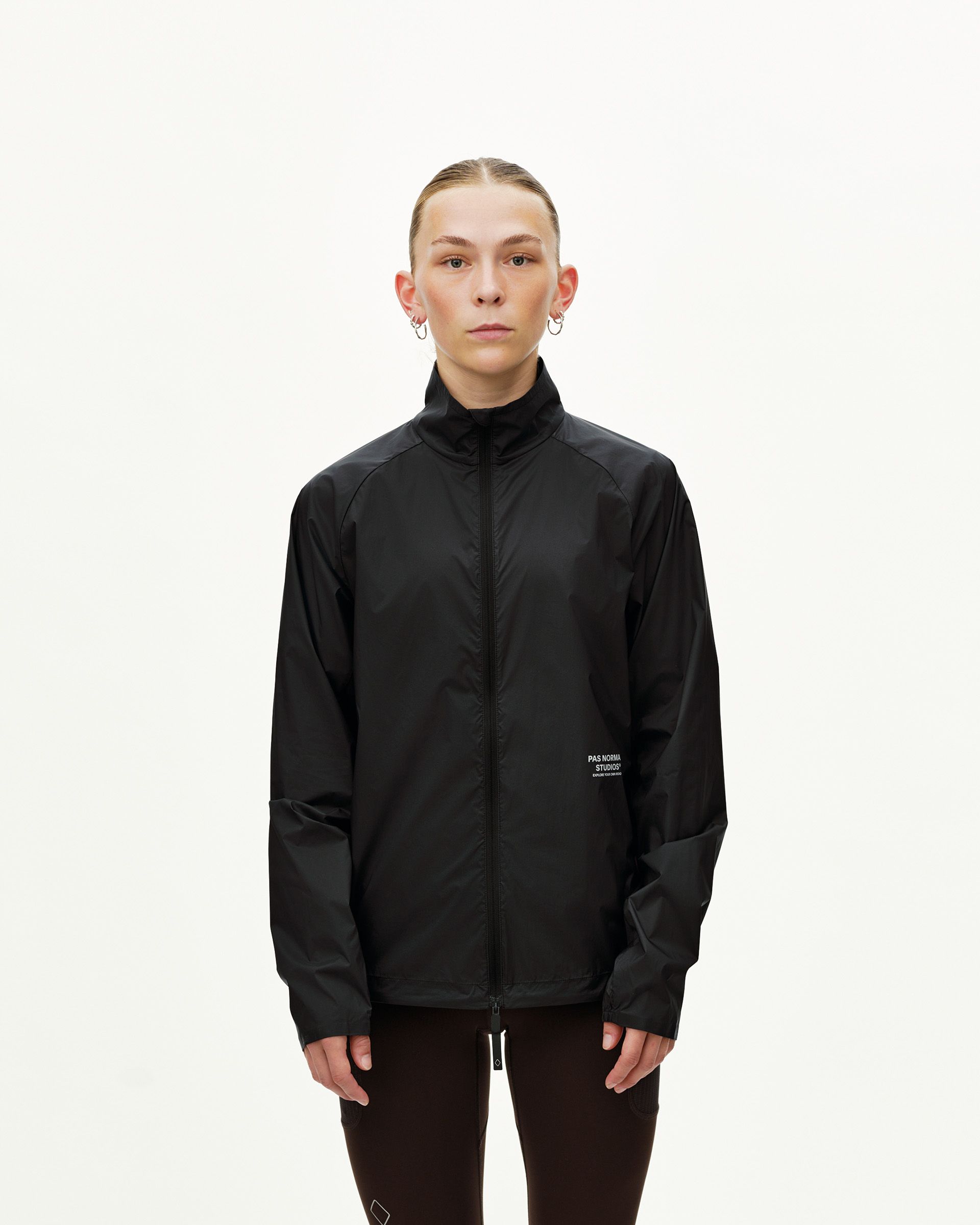 Black Balance Windproof jacket on model, front view with full zip and stand collar