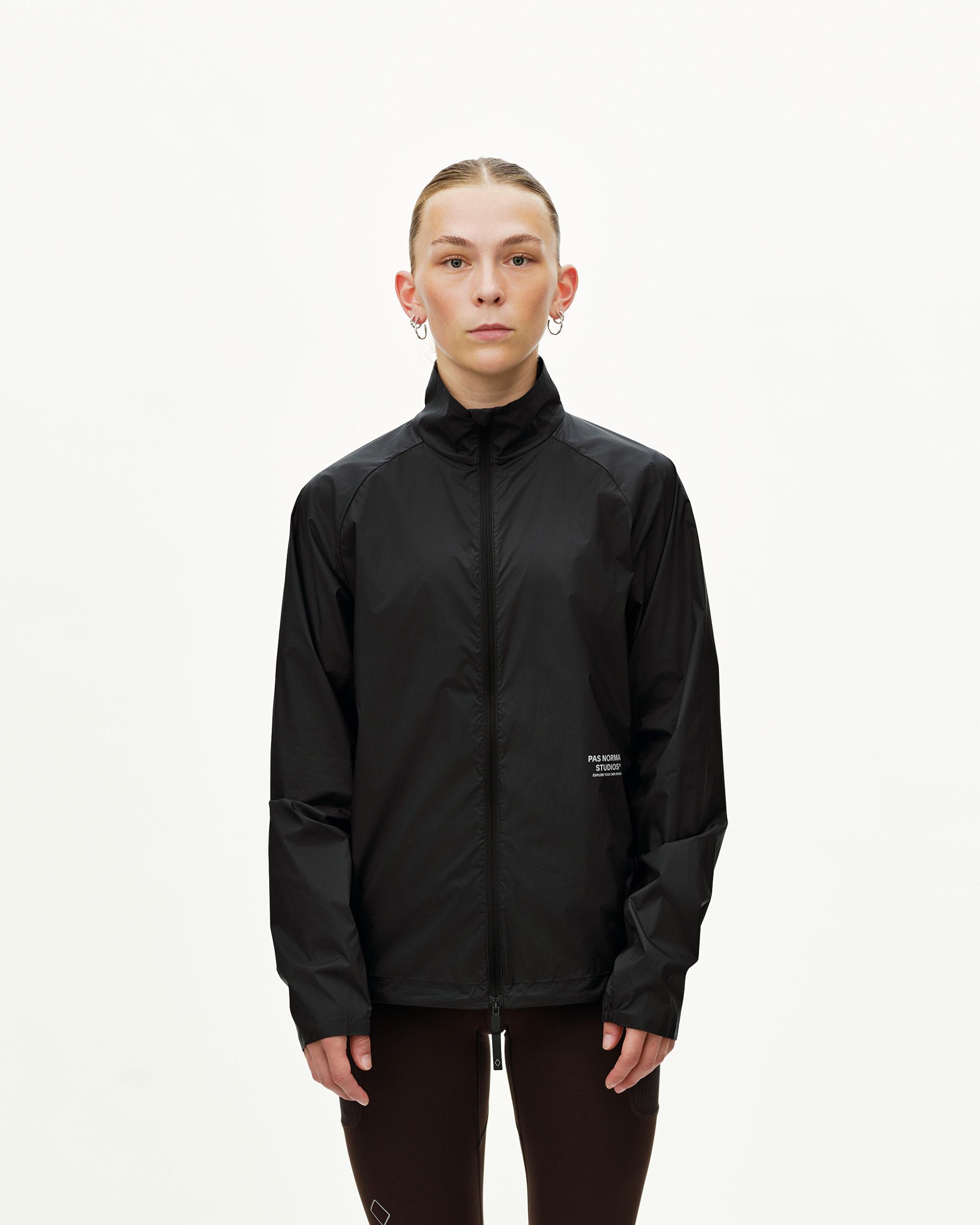 Black Balance Windproof jacket on model, front view with full zip and stand collar
