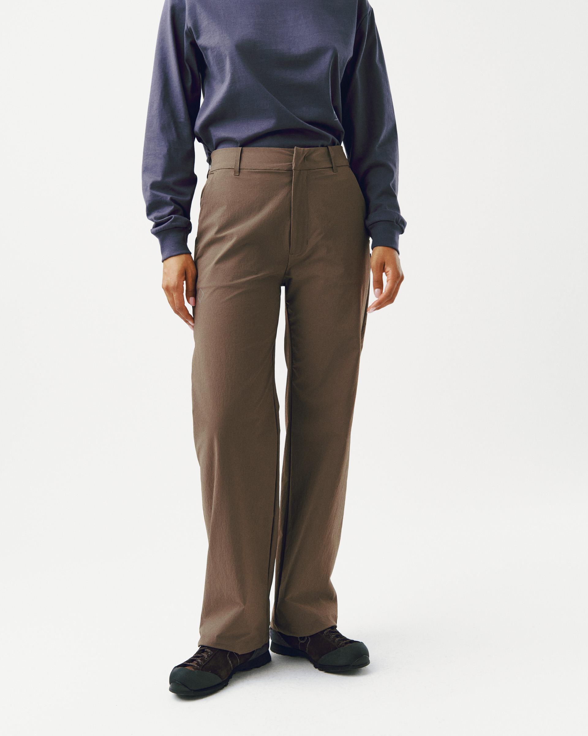 Brown Off-Race Tech pants on model, front view with tailored fit and belt loops