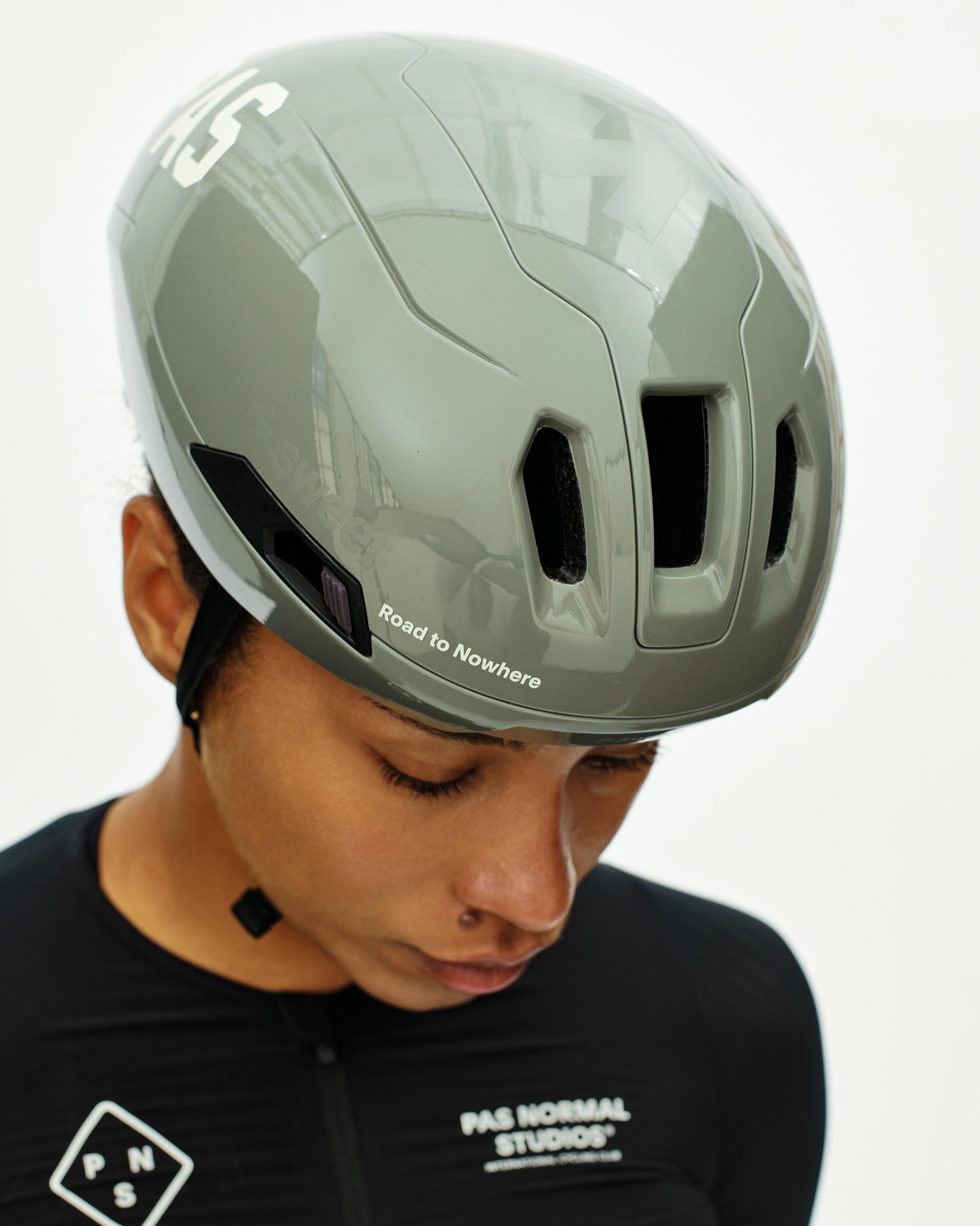 Grey PAS Tucker III 2Vi MIPS cycling helmet on model with aerodynamic vents and Road to Nowhere text