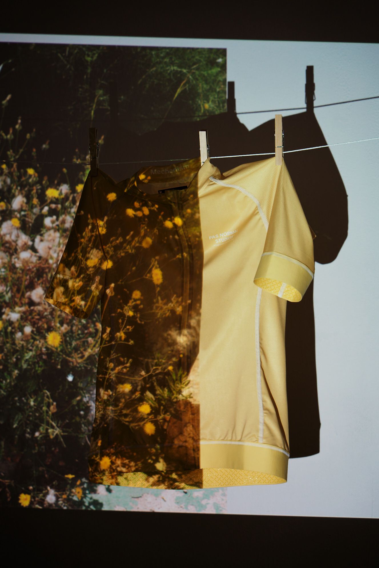 Yellow cycling jersey hanging on clothesline with floral reflection overlay