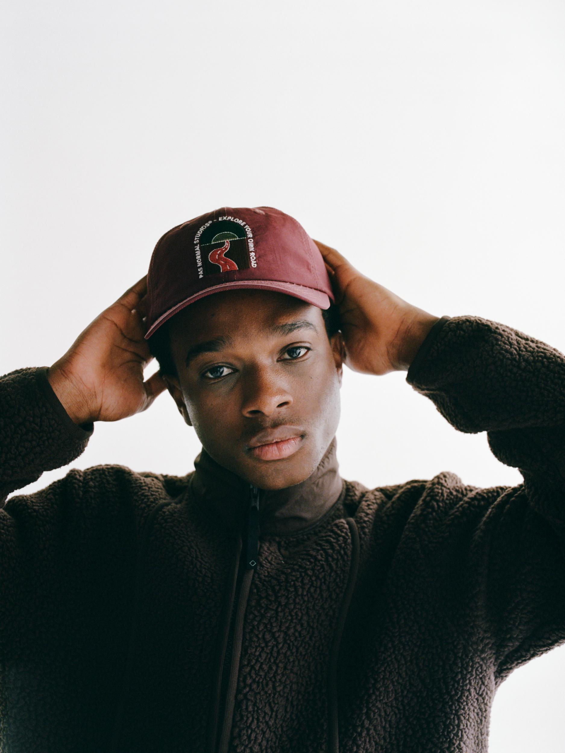 Maroon Off-Race cap on model with circular logo patch