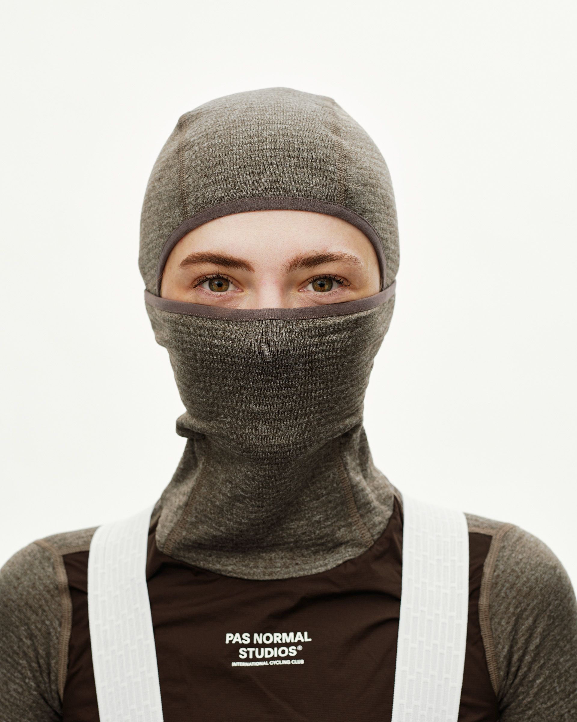 Dark Coffee brown Essential cycling balaclava on model, front view with contrast trim around eye opening