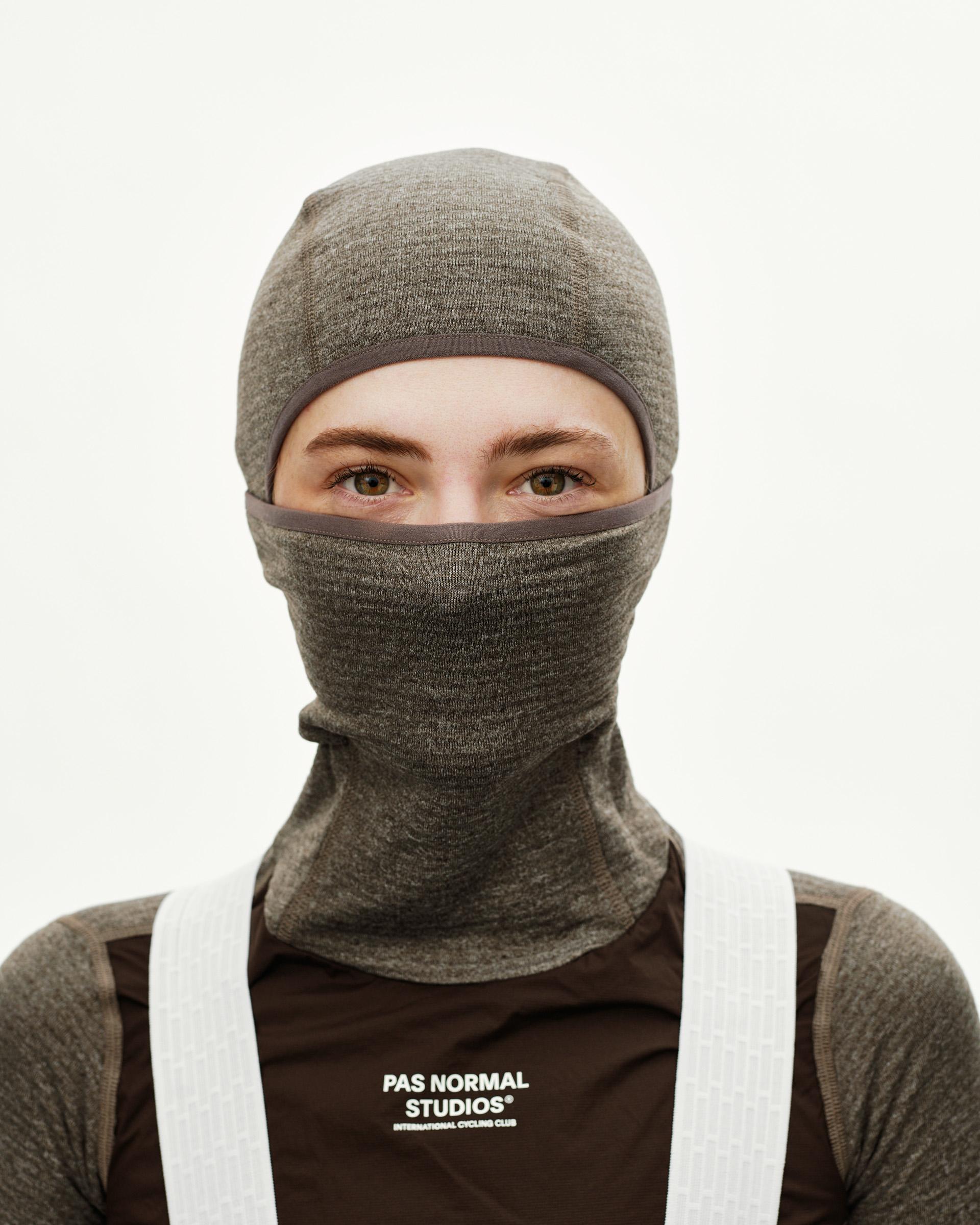 Dark Coffee brown Essential cycling balaclava on model, front view with contrast trim around eye opening