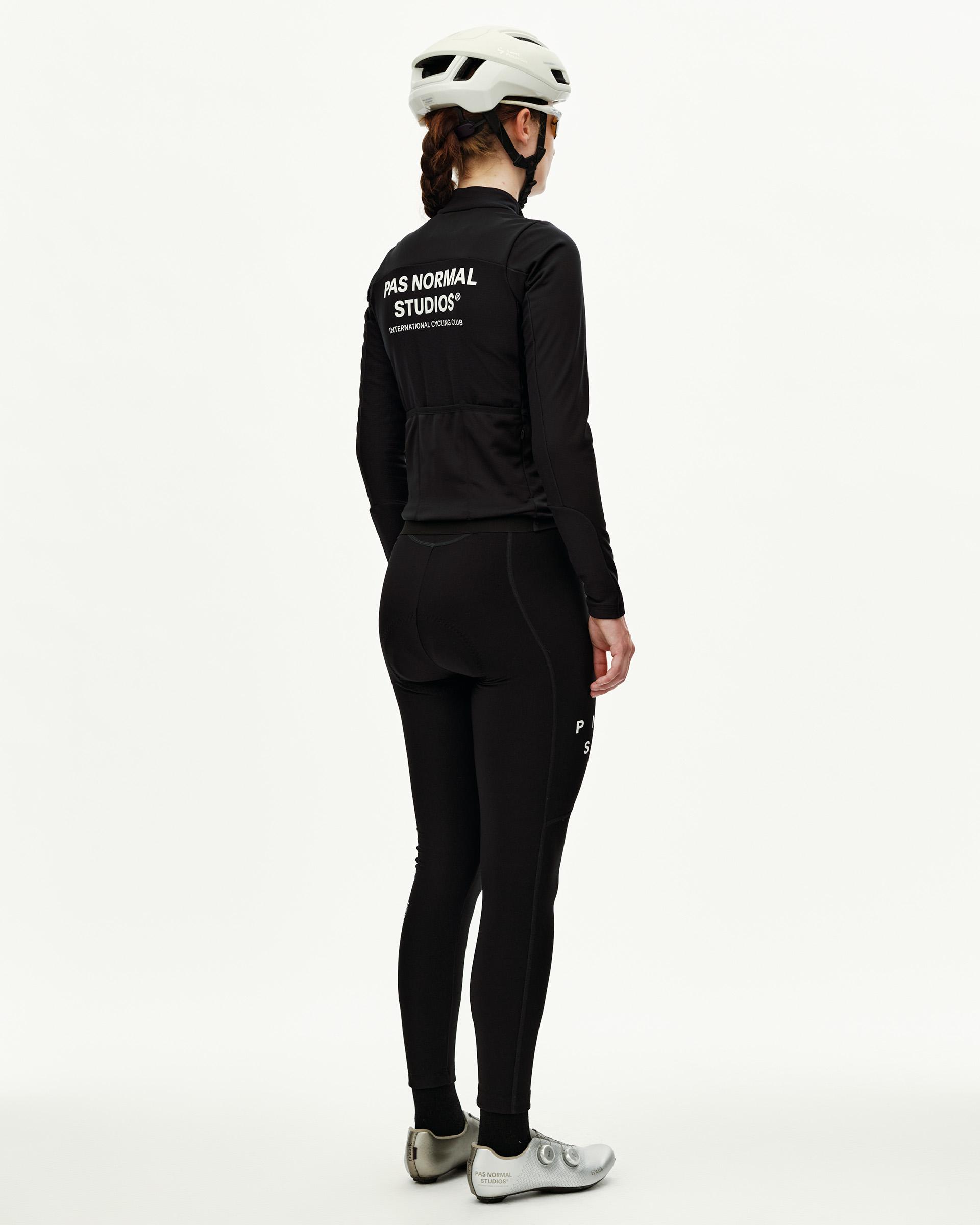 Black Mechanism Thermal Long Sleeve cycling jersey on model, rear view with white back print