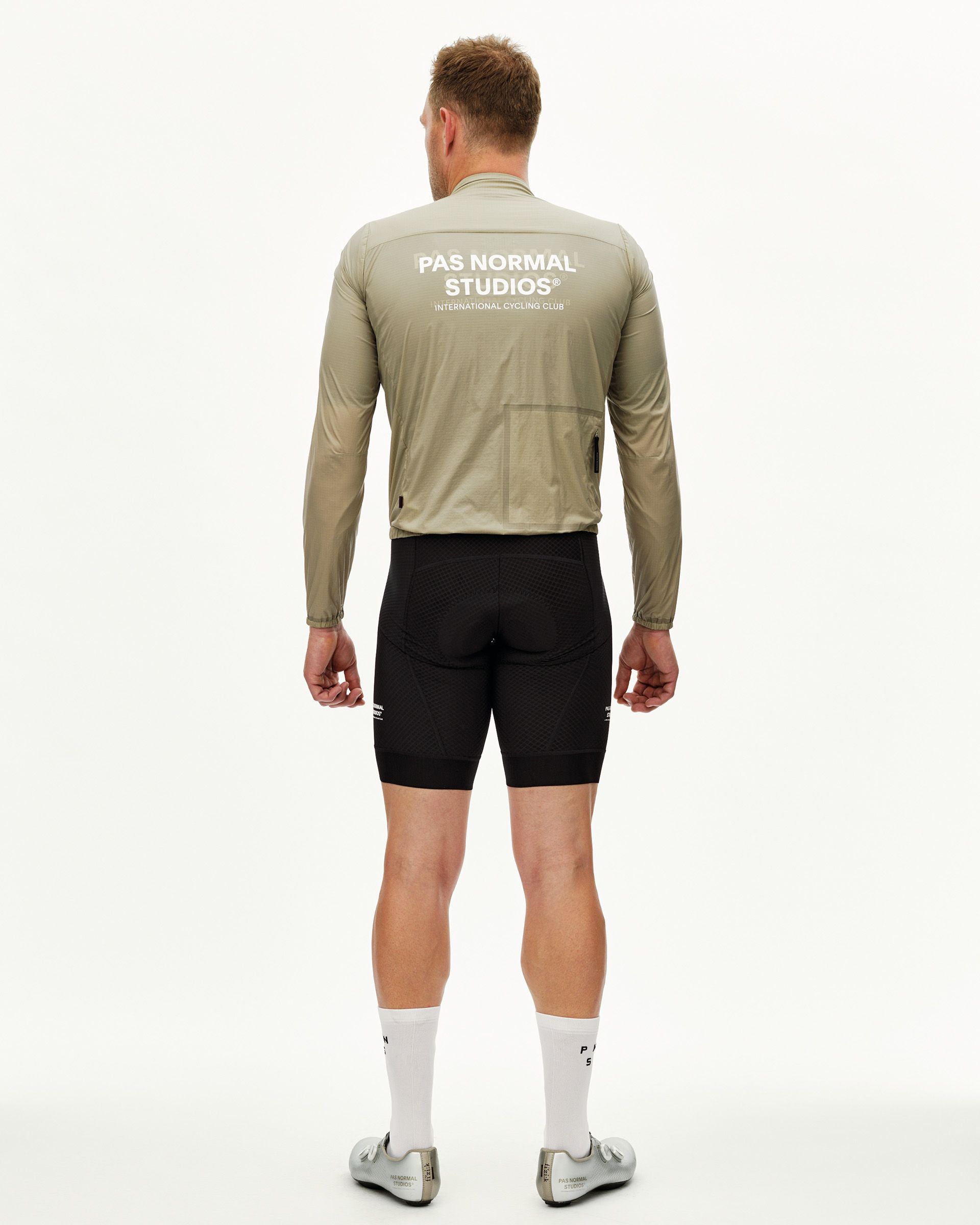 Grey Sage Essential Insulated cycling jacket on model, rear view with white back print