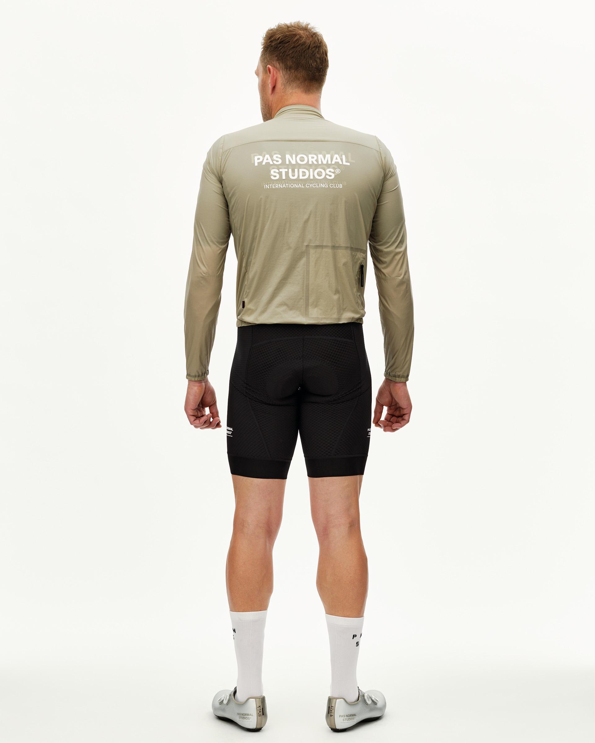 Grey Sage Essential Insulated cycling jacket on model, rear view with white back print