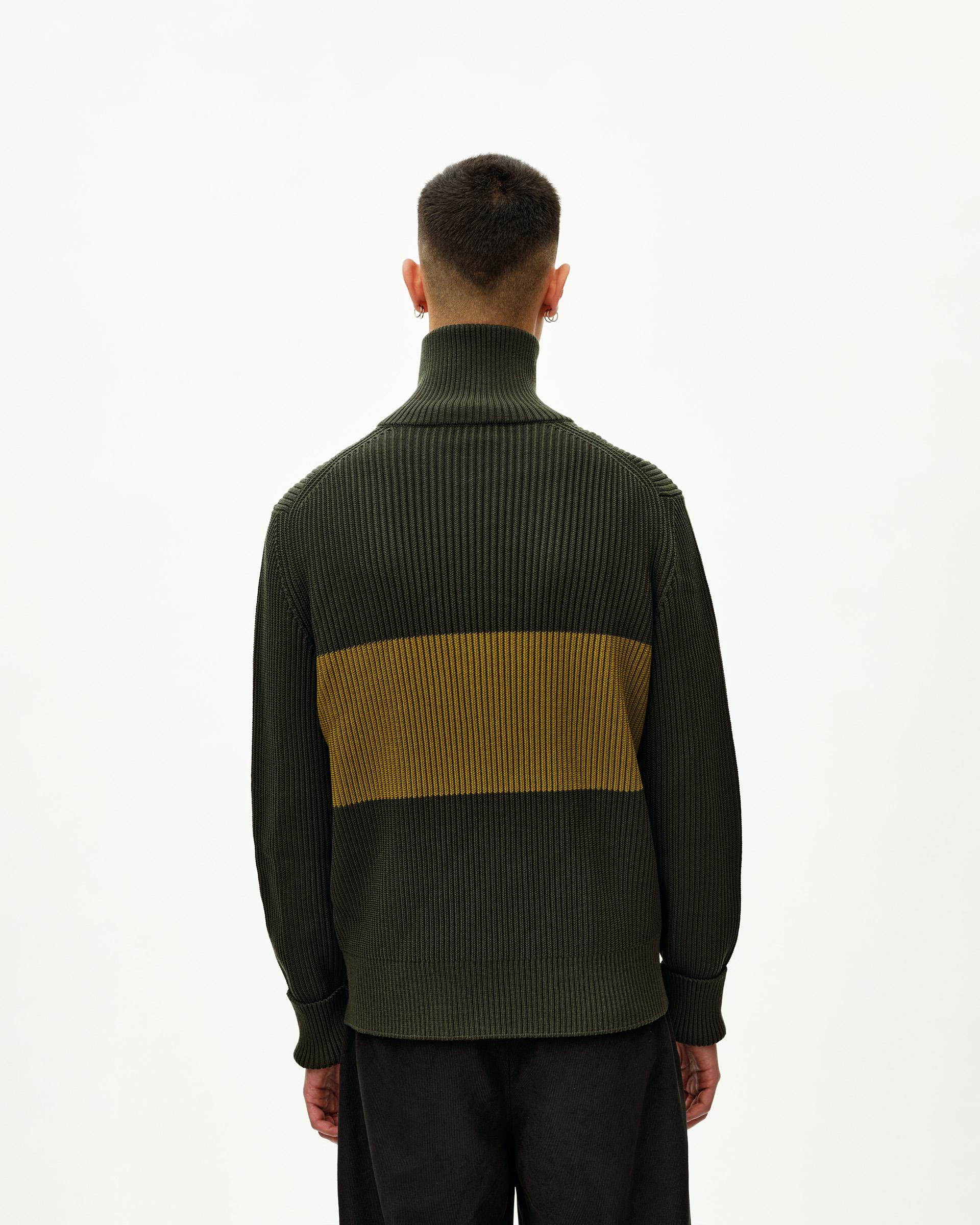 Olive Off-Race Merino Knit Half-Zip sweater, rear view on model with yellow contrast stripe panel