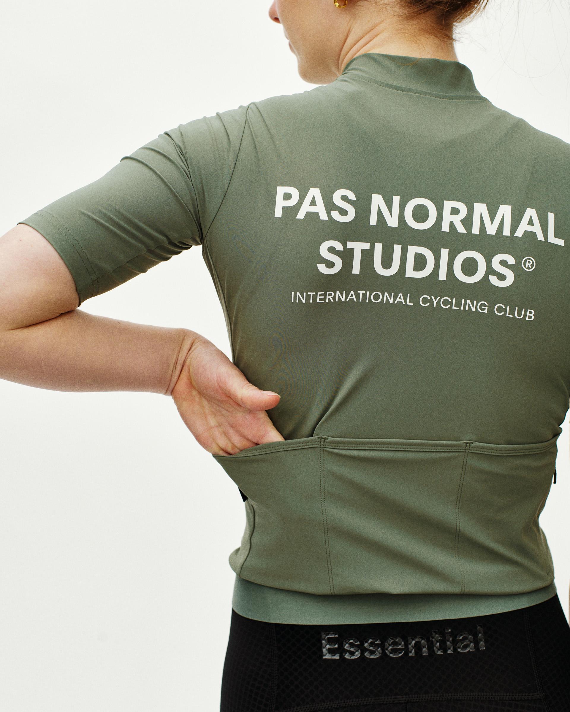 Green Essential cycling jersey, rear view on model with white back print