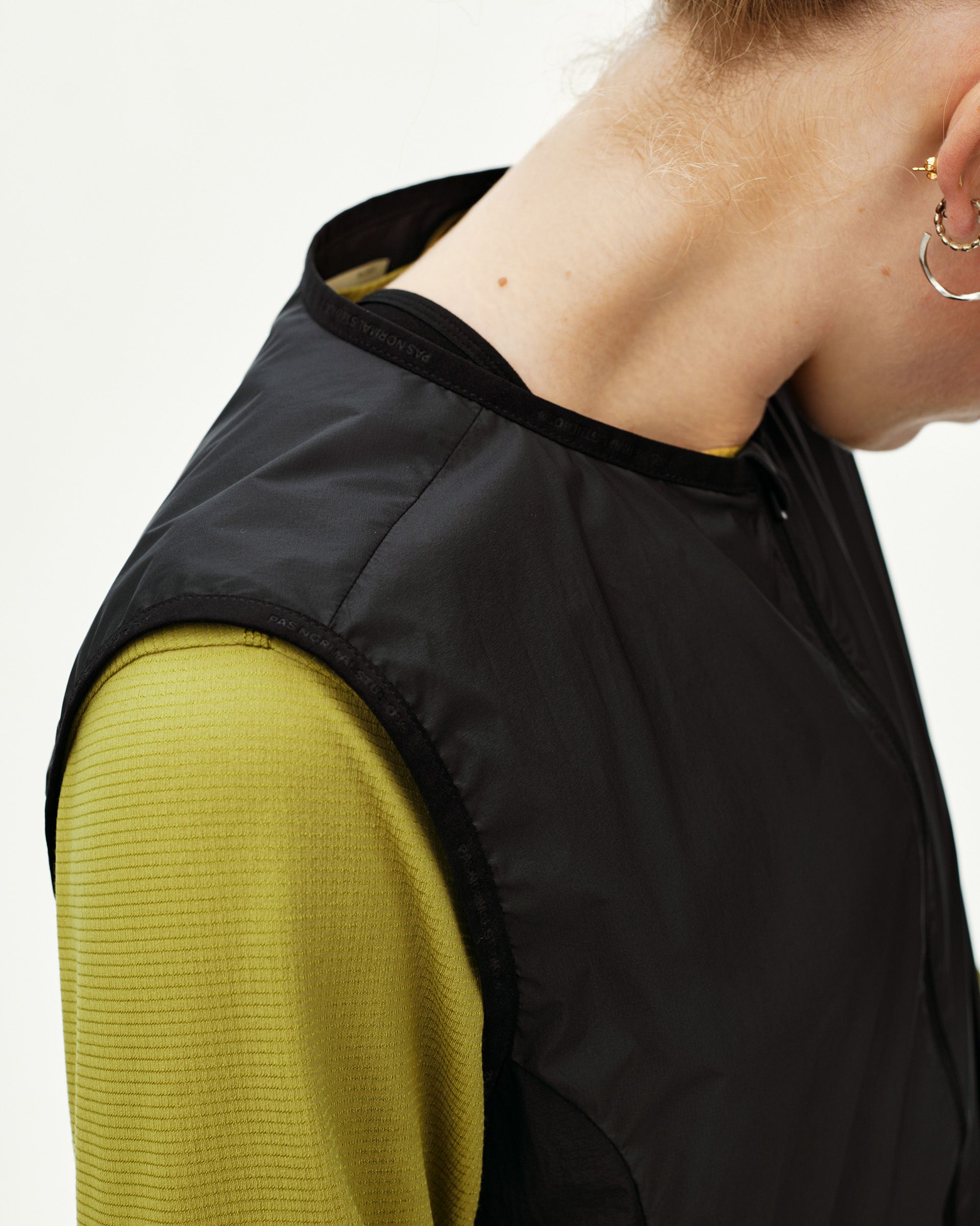 Black Balance Windproof Vest, shoulder detail on model with branded collar tape