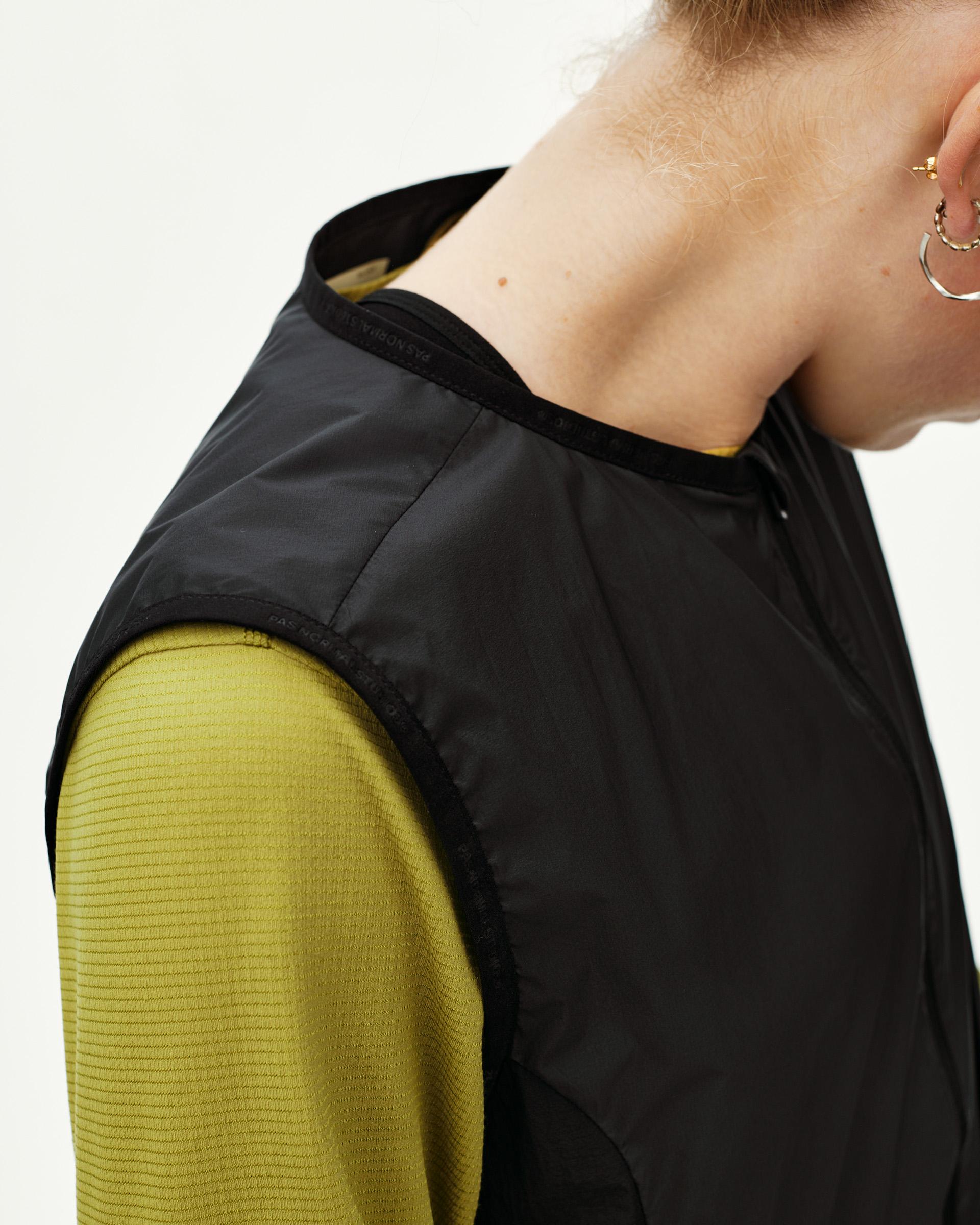 Black Balance Windproof Vest, shoulder detail on model with branded collar tape