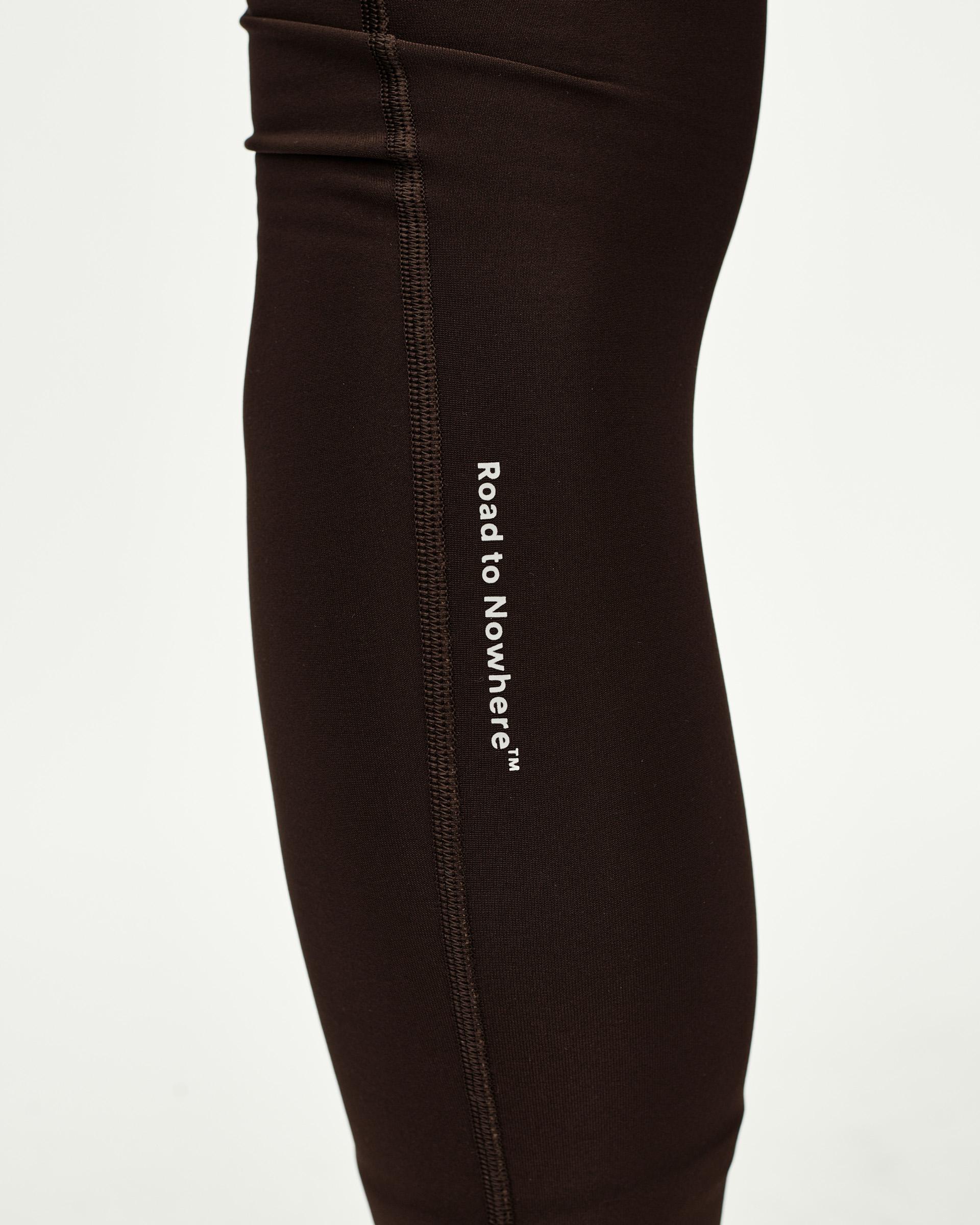 Dark Coffee brown Mechanism Thermal Long cycling bibs, side detail on model with white Road to Nowhere leg print