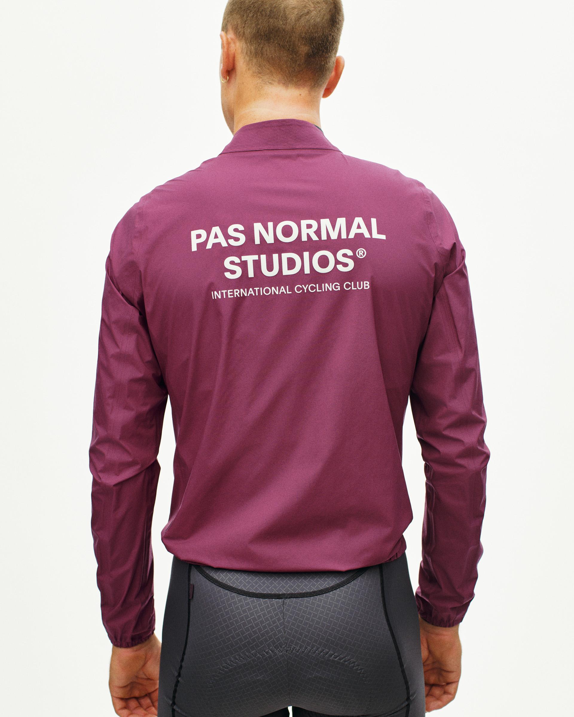 Purple Mechanism Rain cycling jacket, rear view on model with white back logo