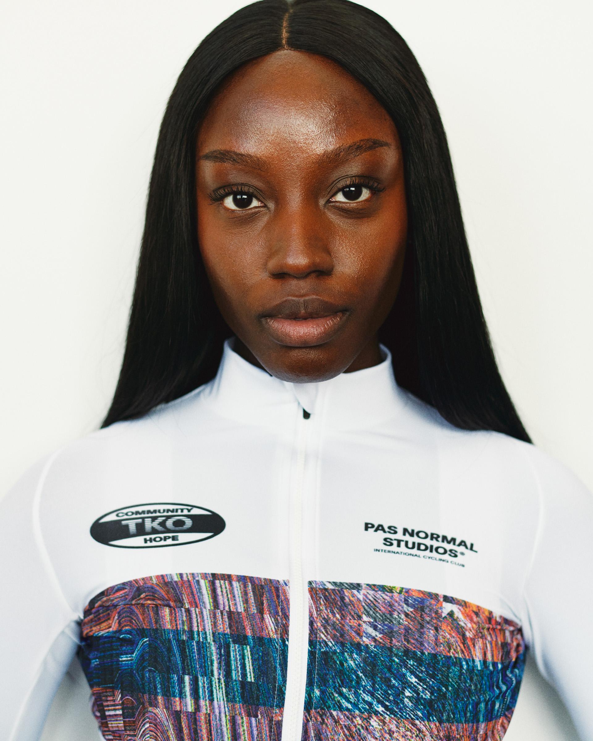 White T.K.O. Mechanism long sleeve cycling jersey on model, front view with multicolour graphic lower panel