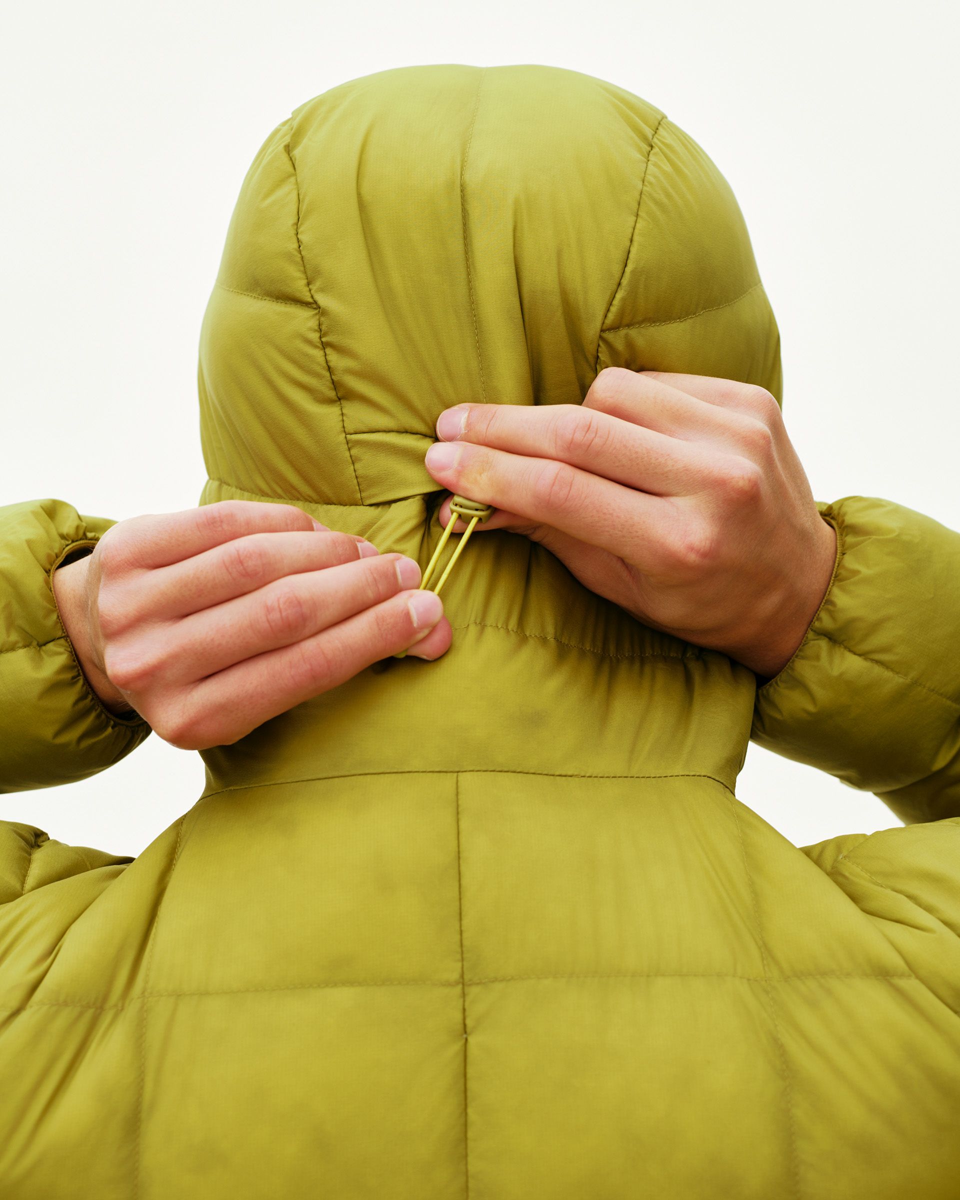 Dark Lime green Off-Race Down Liner jacket on model, rear detail view with hood drawcord adjustment