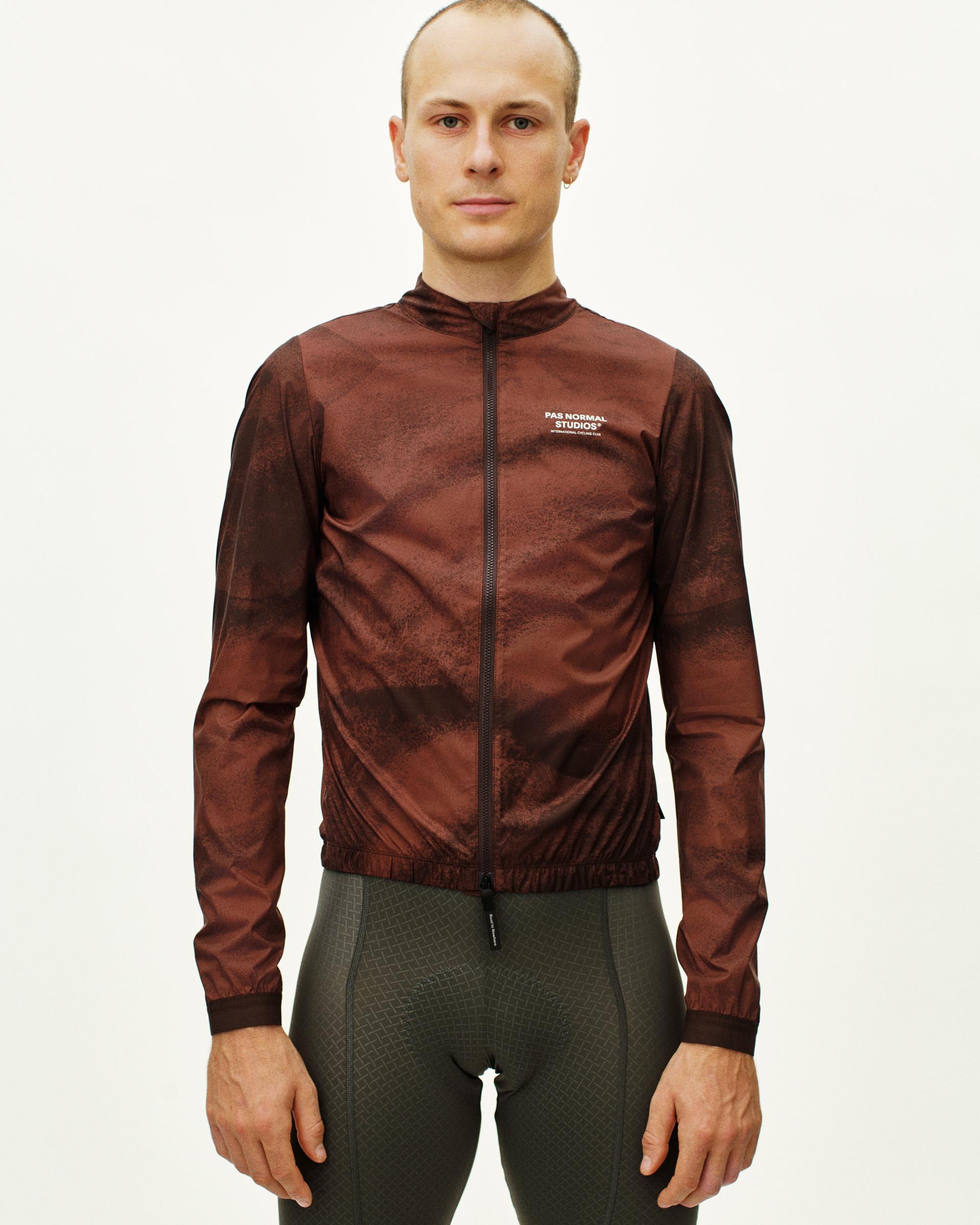 Light Brown Mechanism Stow Away jacket on model with textured brown pattern and elastic hem