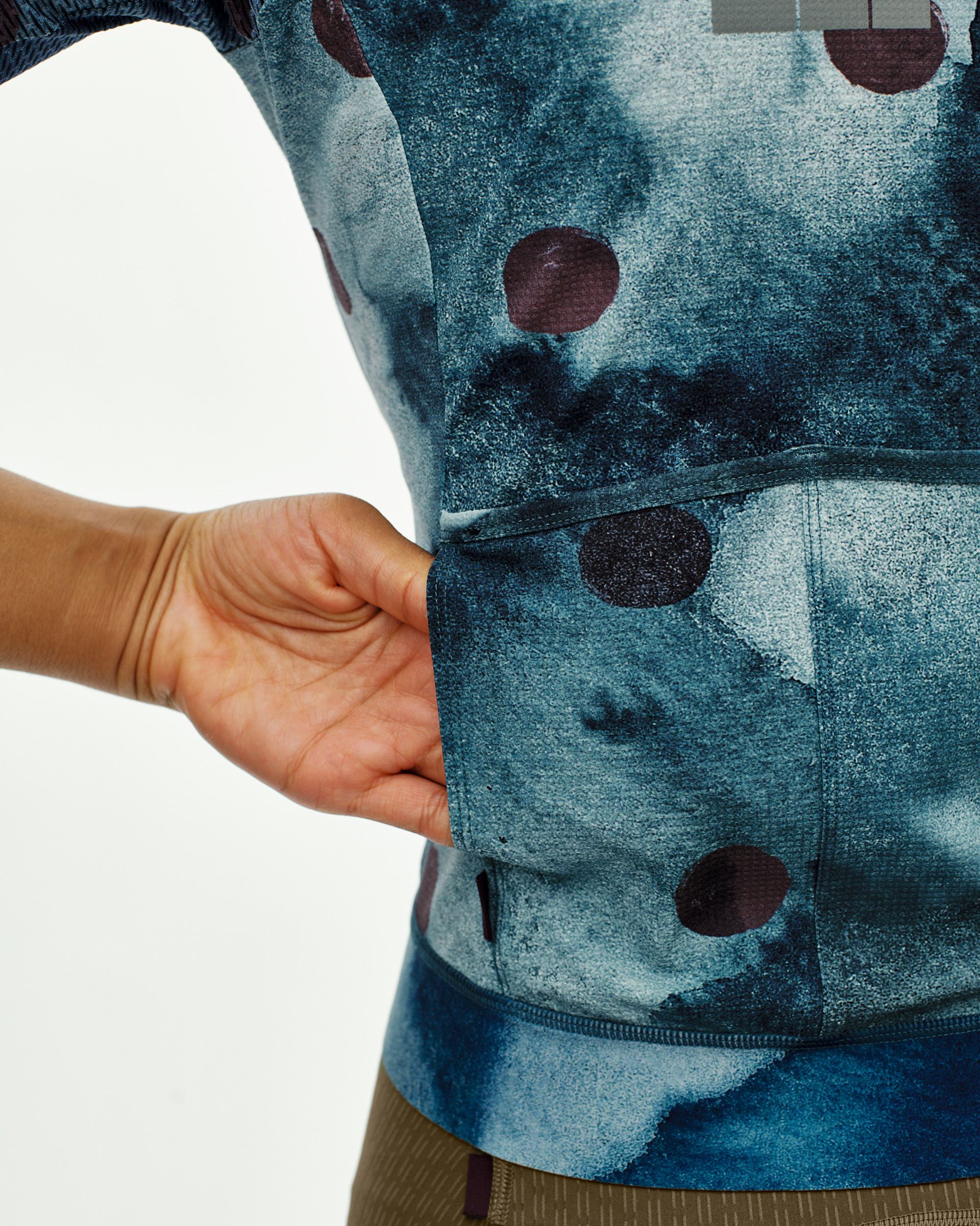 Dark Purple T.K.O. Essential Light cycling jersey on model with polka dot print