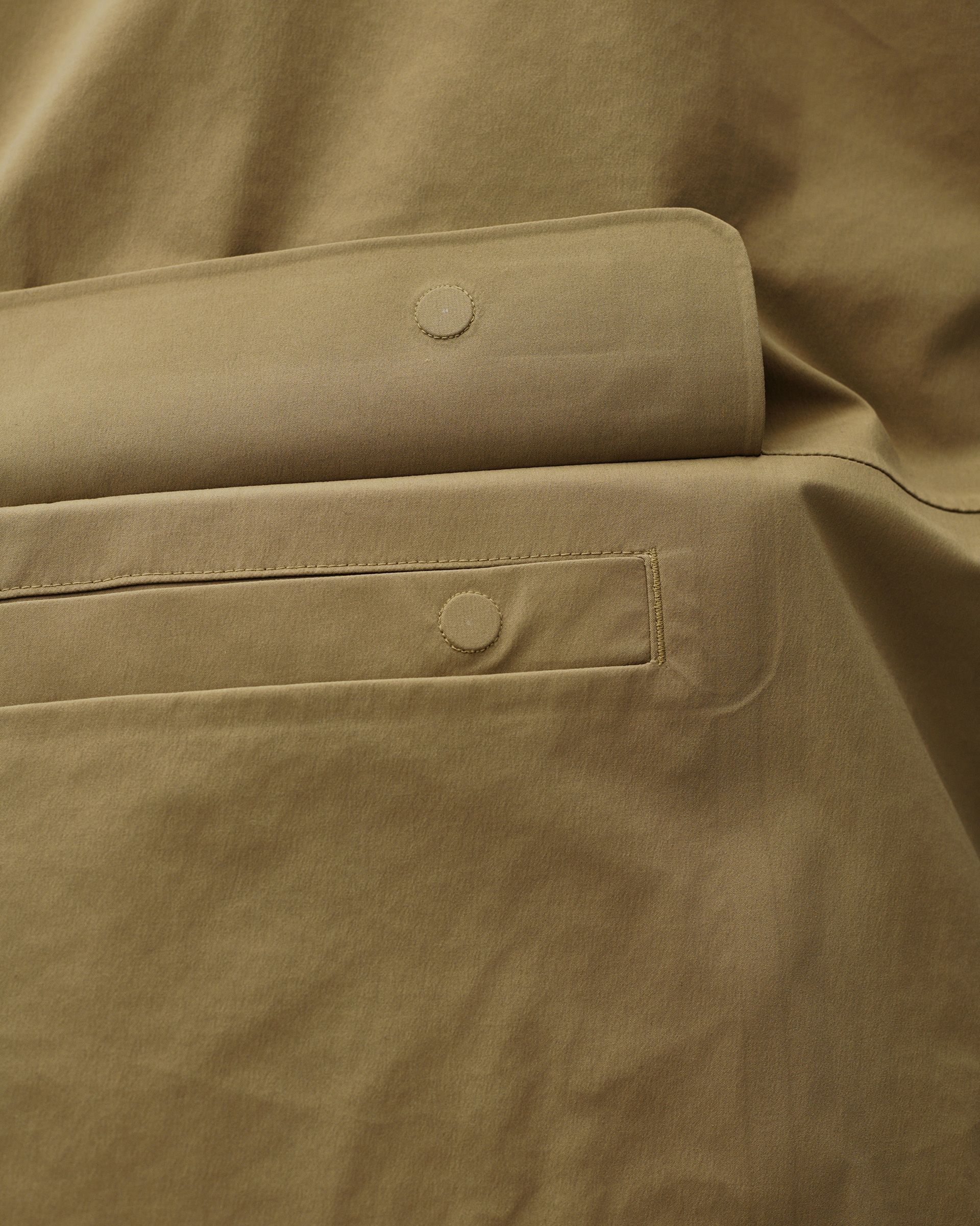 Brown Off-Race 3L Shell jacket, detail view of snap-button pocket and cuff