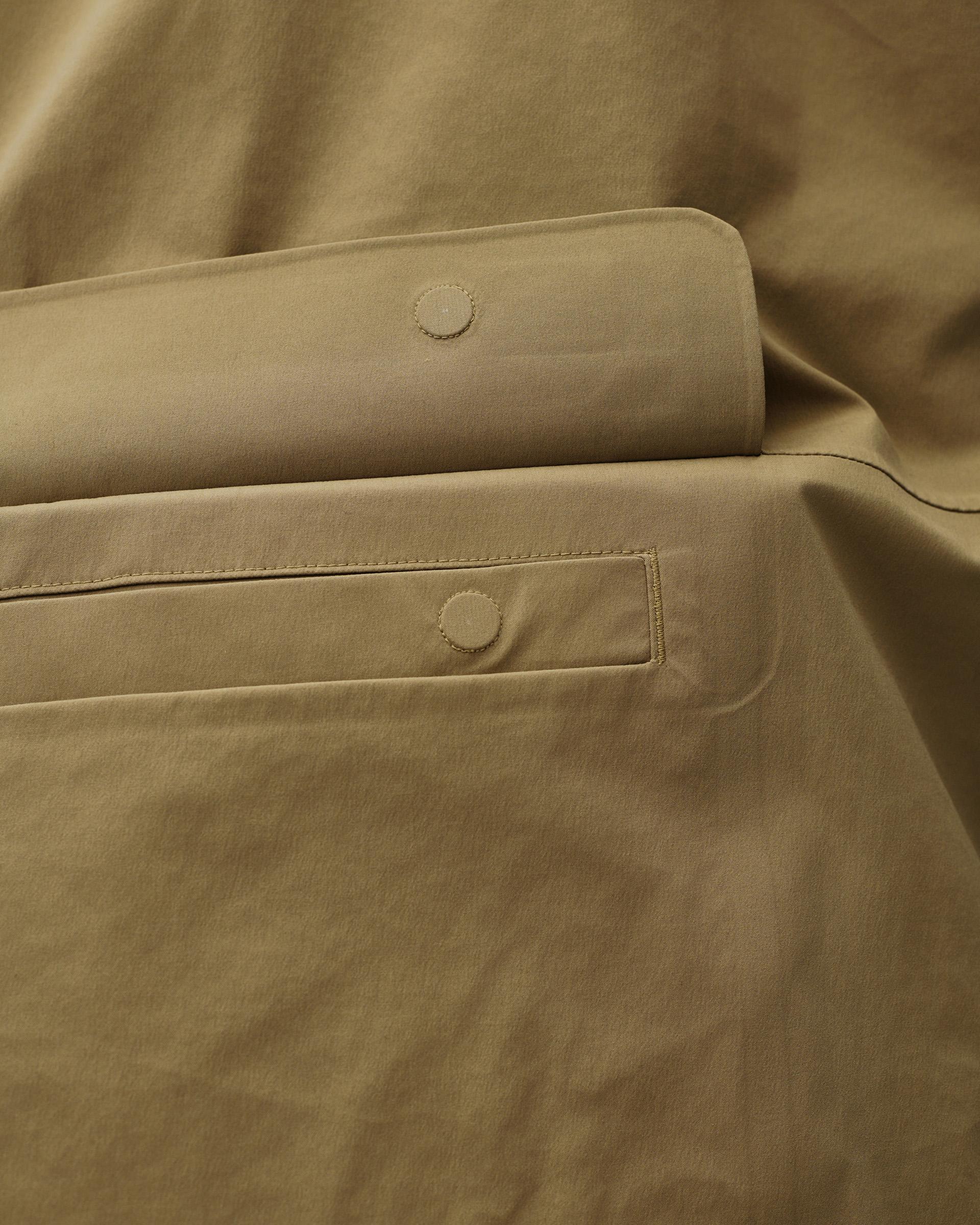 Brown Off-Race 3L Shell jacket, detail view of snap-button pocket and cuff