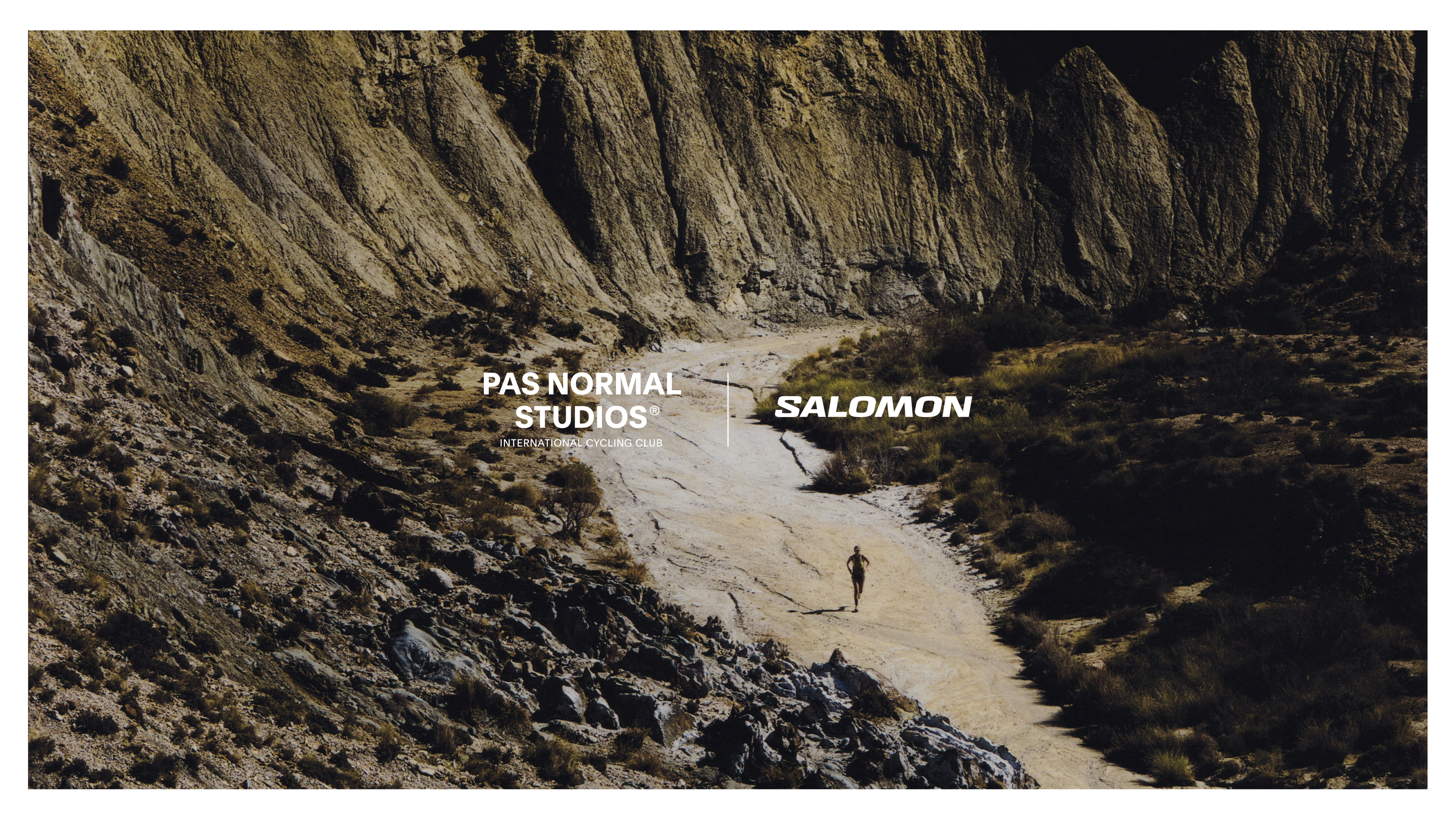 Cyclist running on desert trail through canyon with brand collaboration logos overlaid