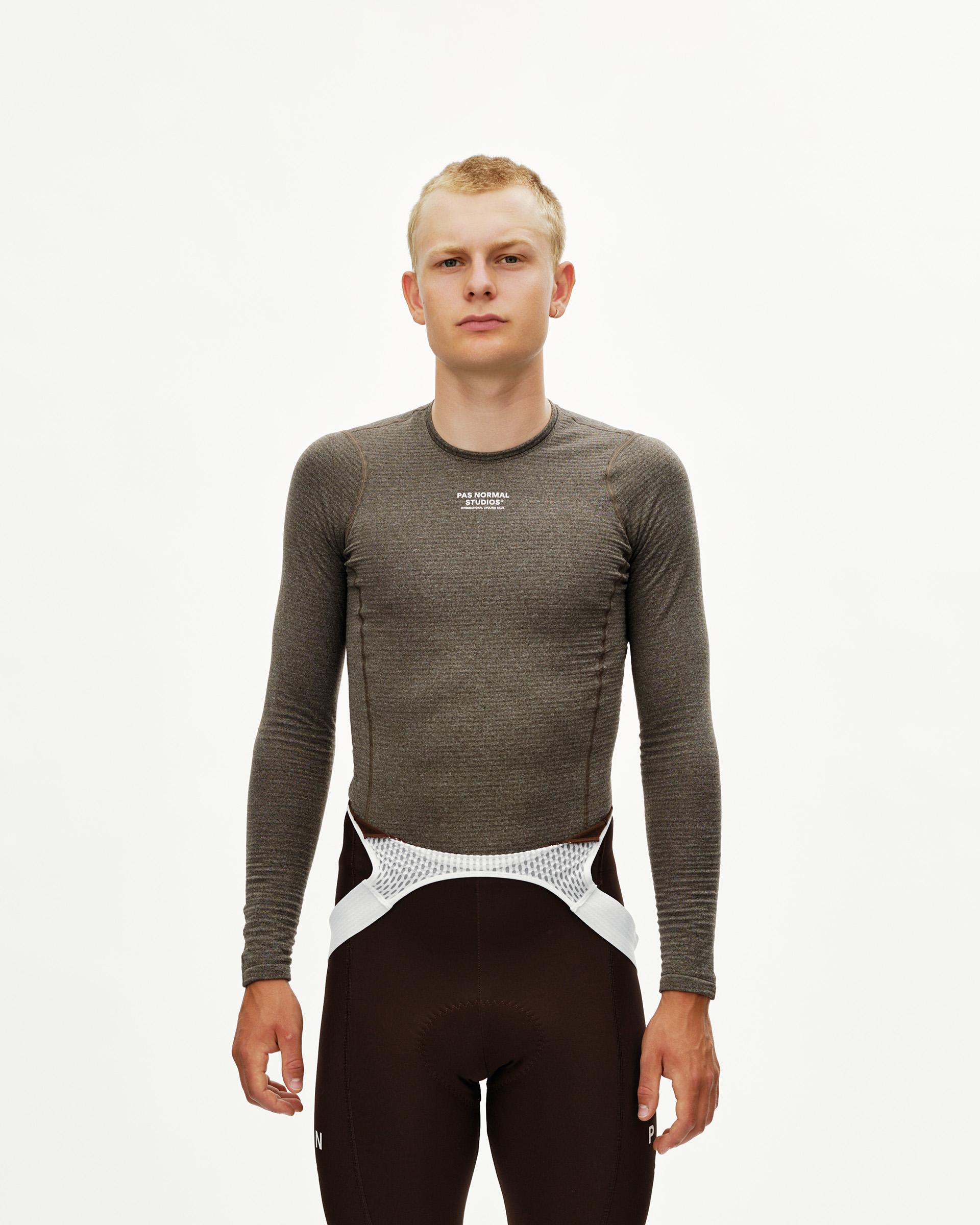 Dark Coffee brown Essential cycling long sleeve baselayer on model, front view with white chest logo