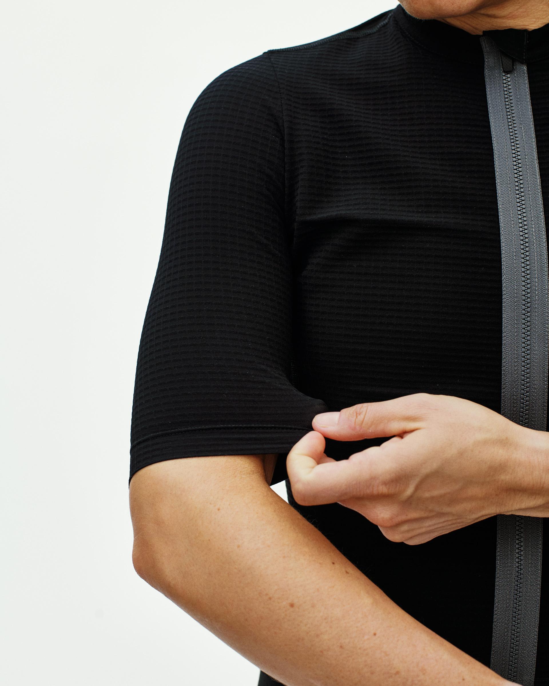 Black Escapism cycling jersey on model with contrast zip and textured fabric