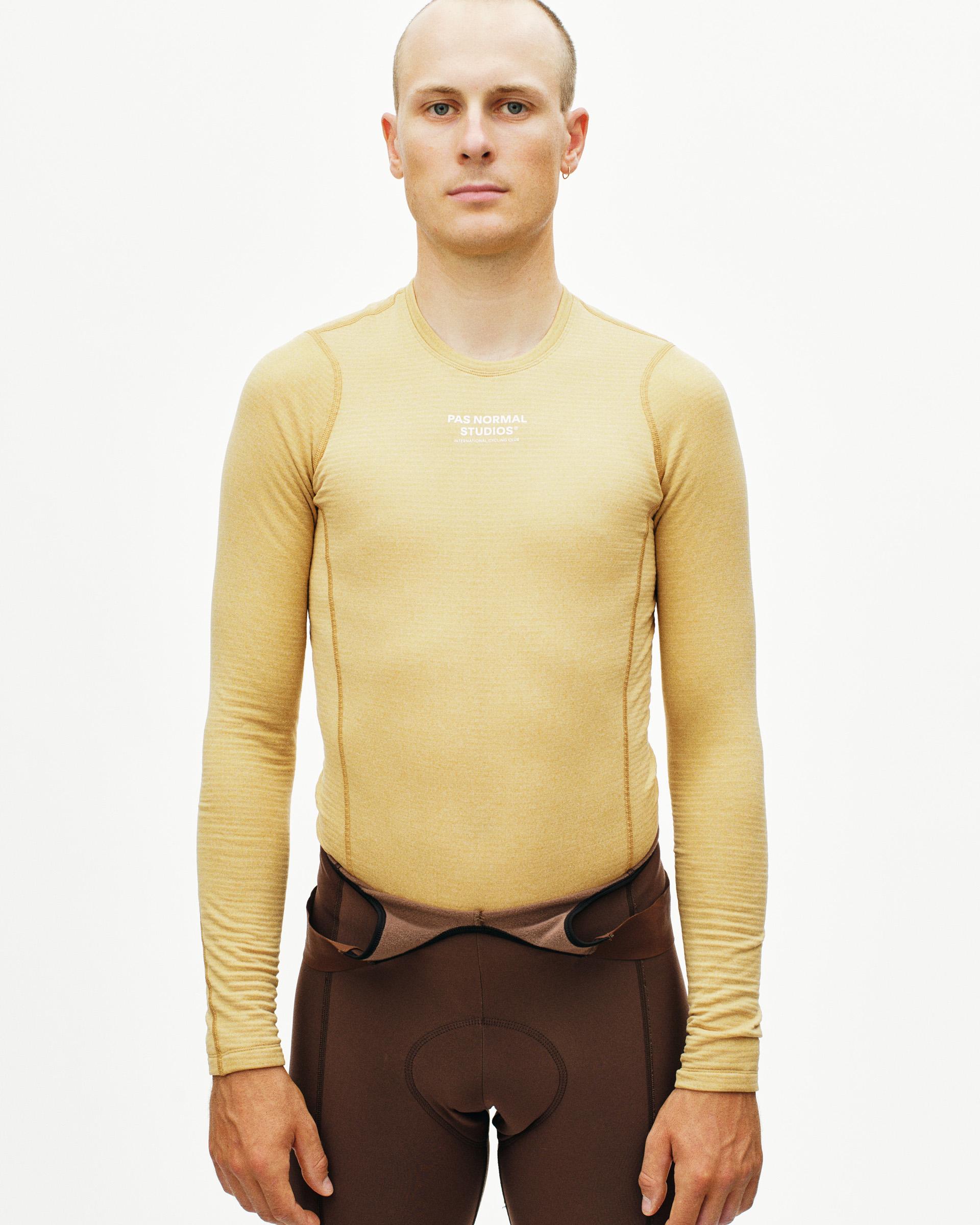 Camel thermal long sleeve base layer on model with white chest logo