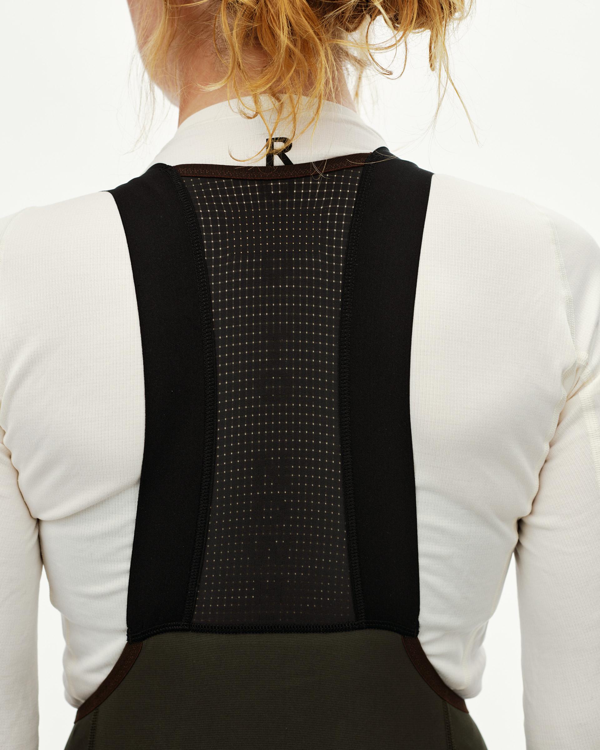 Dark Olive Escapism Long Cargo cycling bibs on model, rear detail view with mesh bib panel