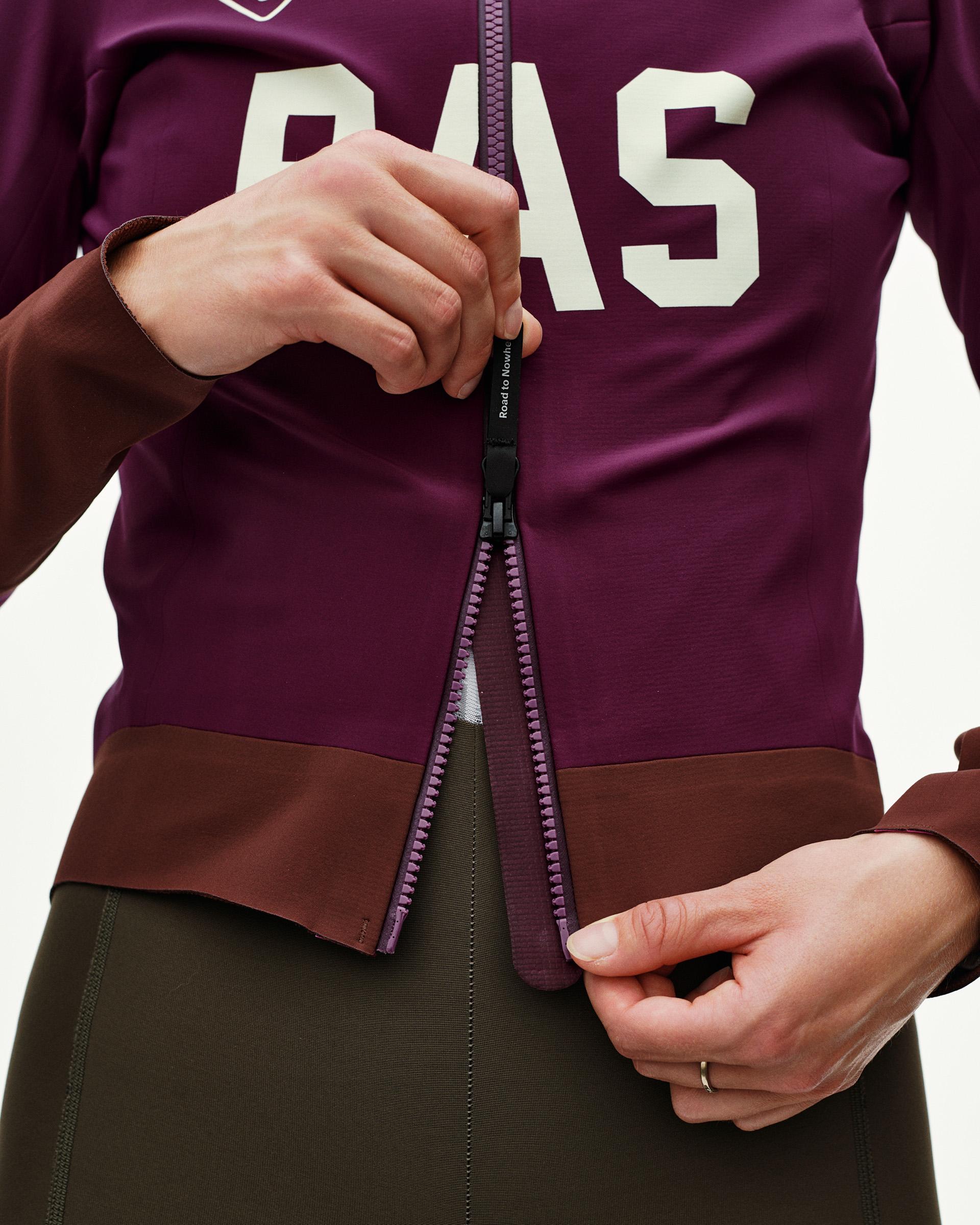 Dark Purple Mechanism women's cycling jacket, front detail on model showing open full-length zip with contrast purple teeth