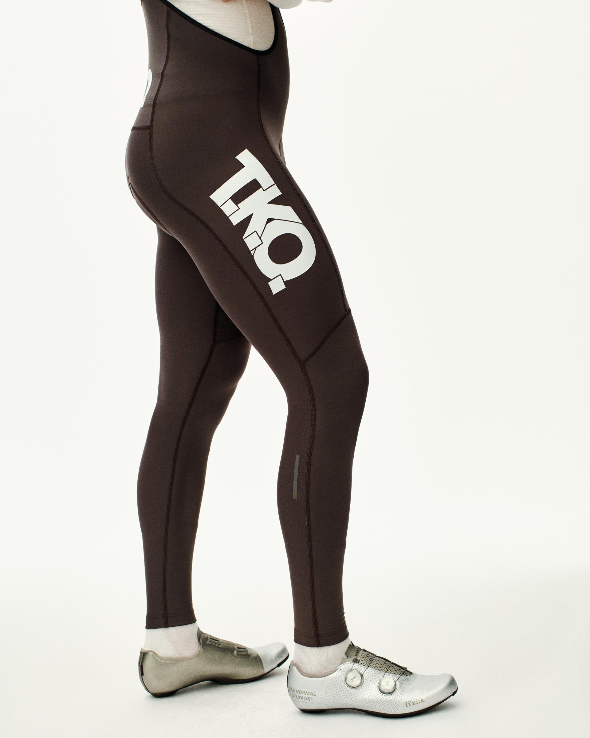 Dark Purple T.K.O. Essential Thermal Long cycling bibs on model, side view with white T.K.O. leg print