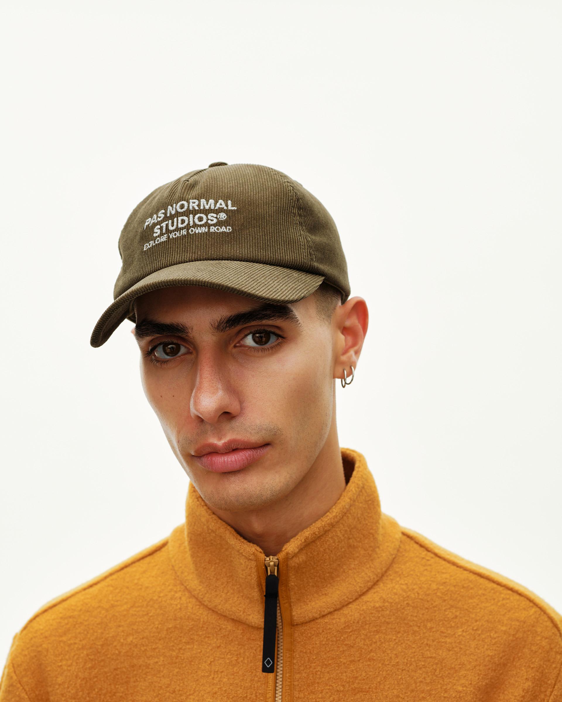 Deep Olive Off-Race Tech Corduroy cap on model, front view with white embroidered logo text