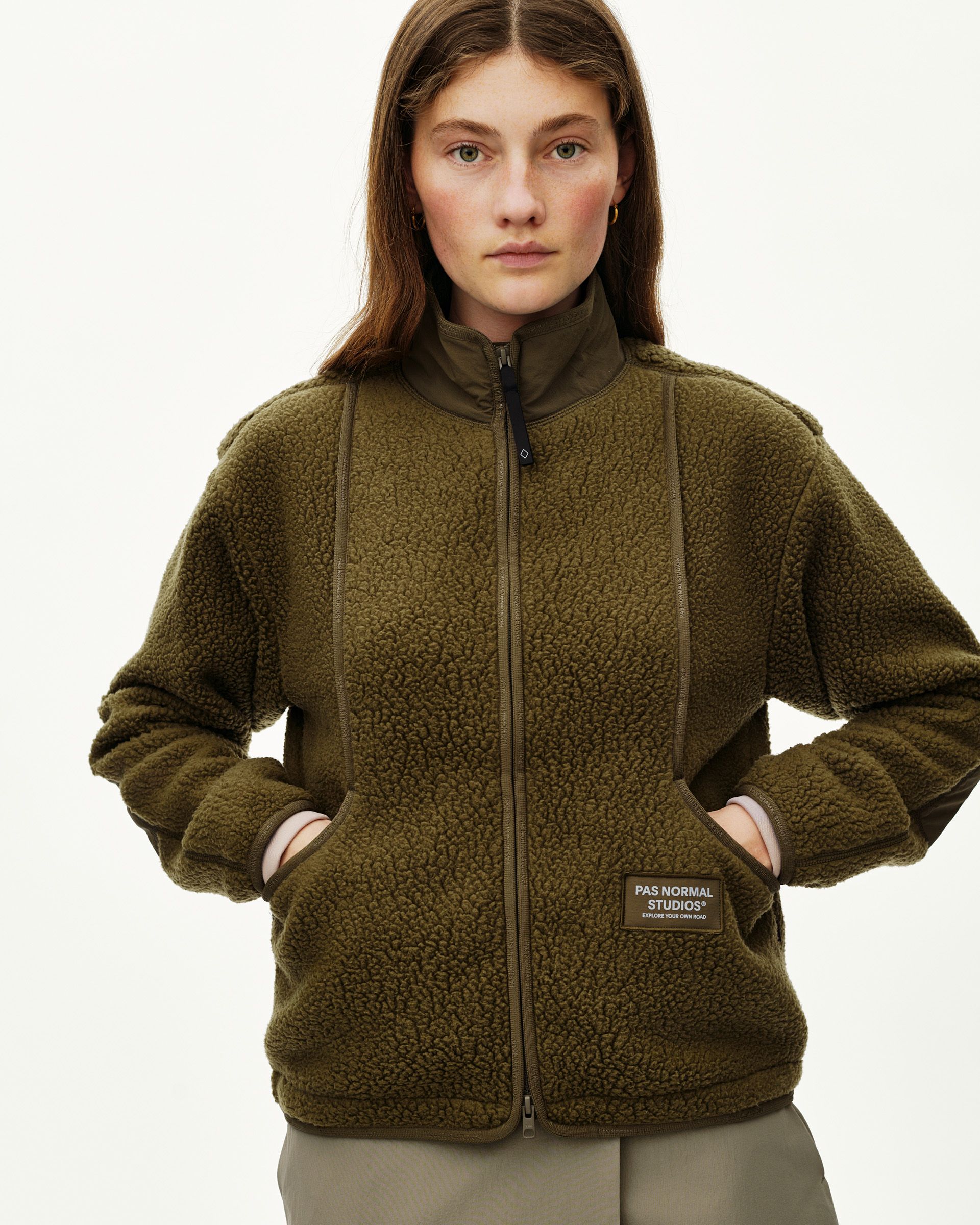 Deep Olive Off-Race Pile Fleece jacket on model, front view with full zip and branded patch