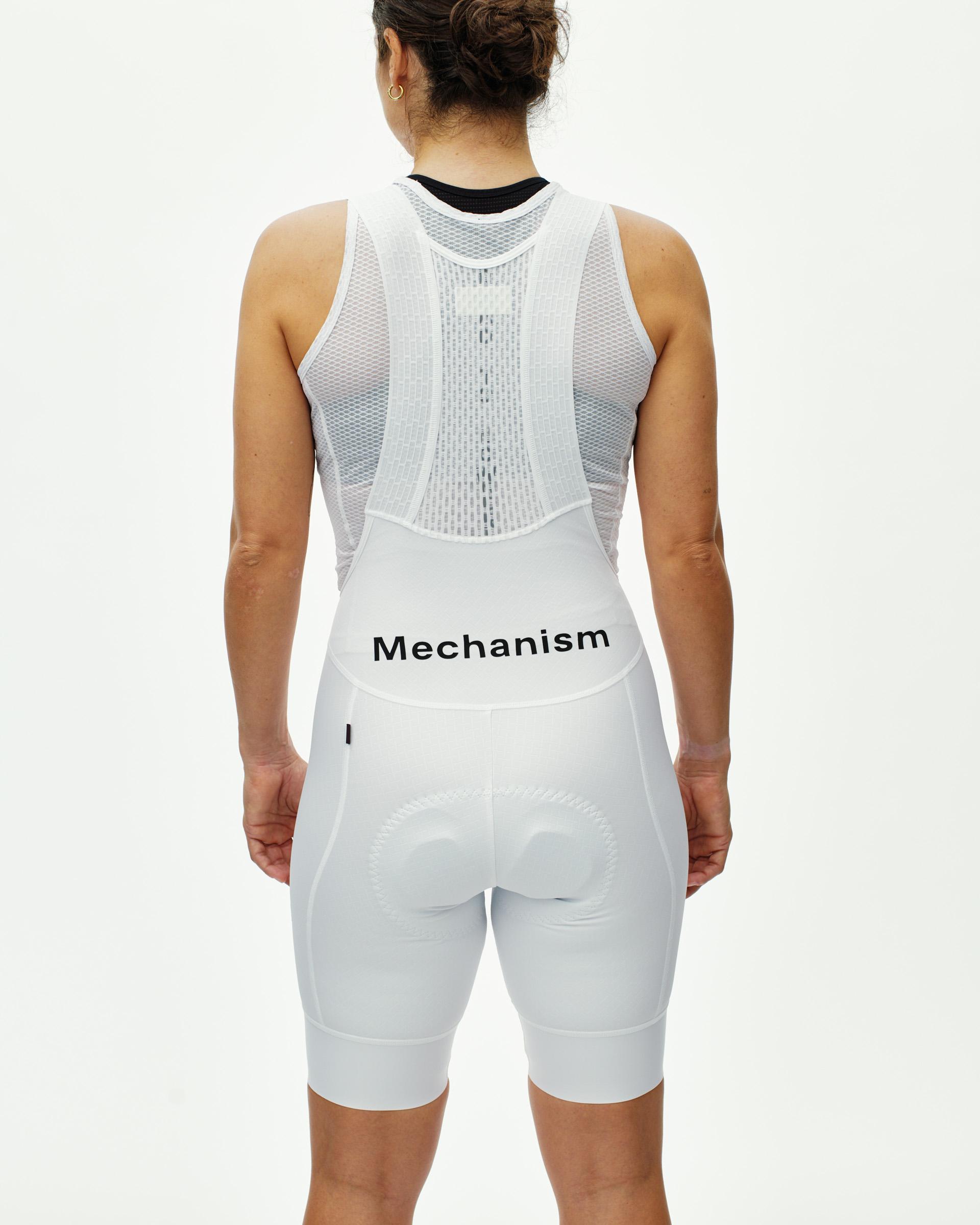 White Mechanism cycling bibs on model, rear view with mesh back panel and black logo