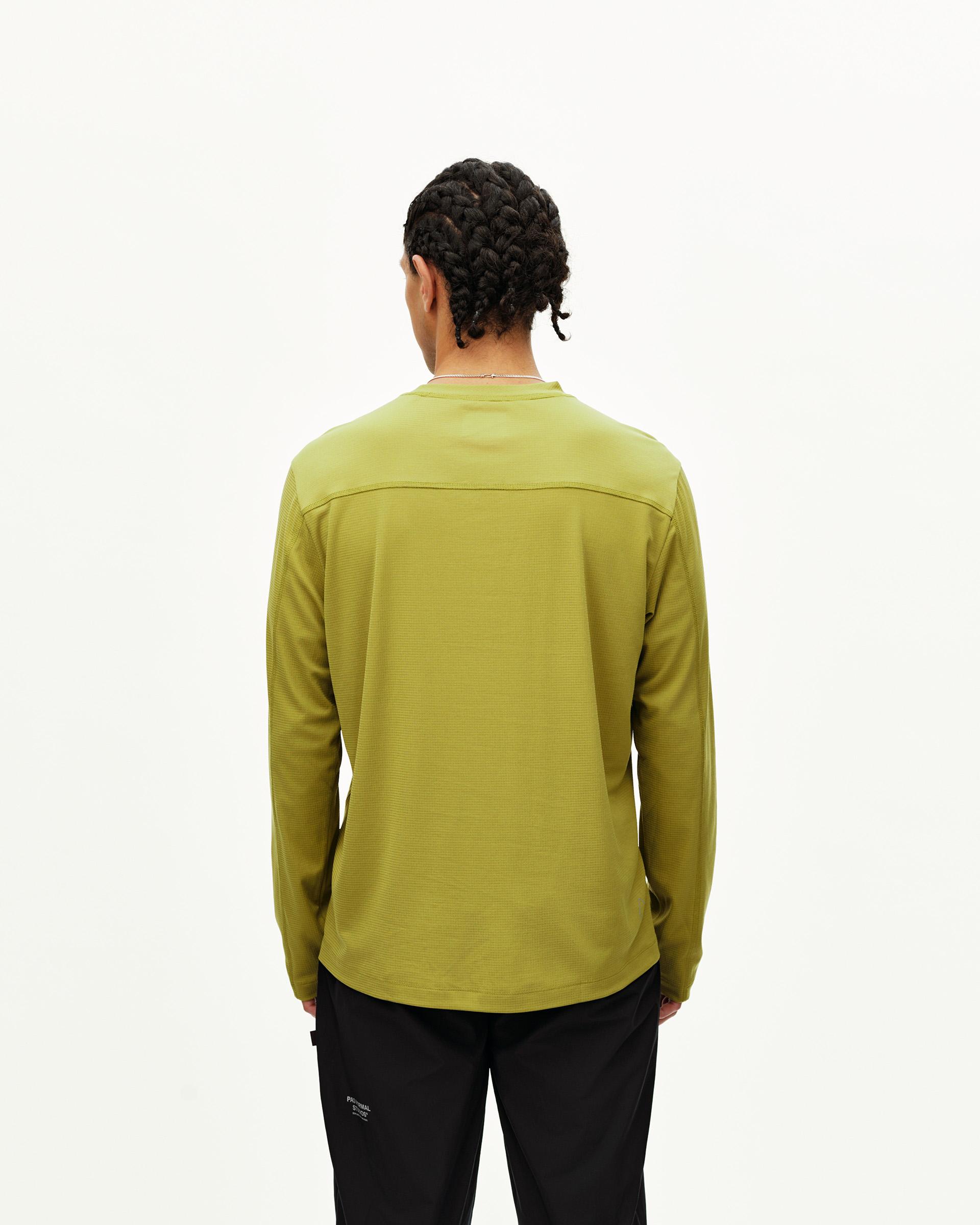 Dark Lime green Balance long sleeve T-shirt on model, rear view with contrast shoulder panel