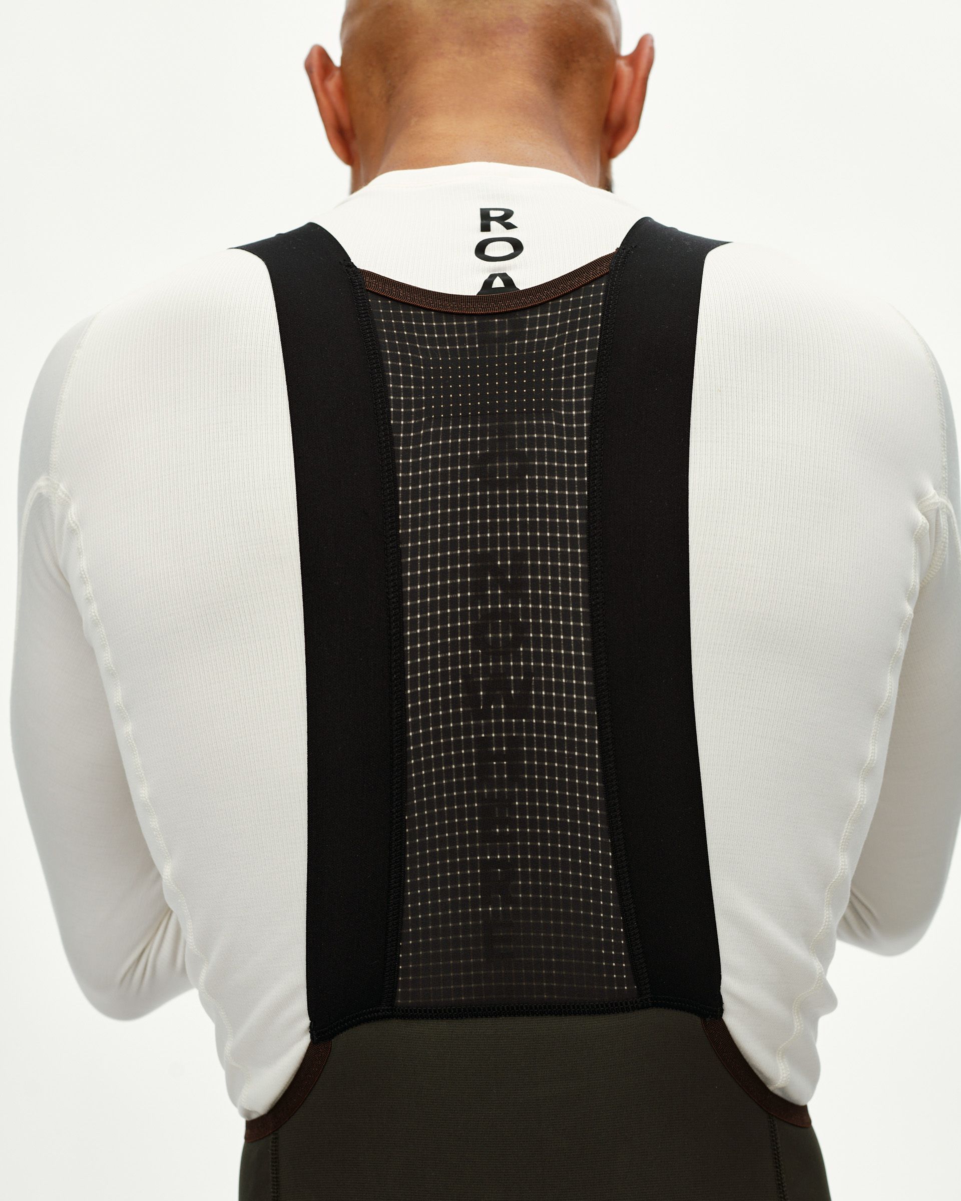 Dark Olive Escapism Long Cargo cycling bibs on model, rear view with mesh bib panel