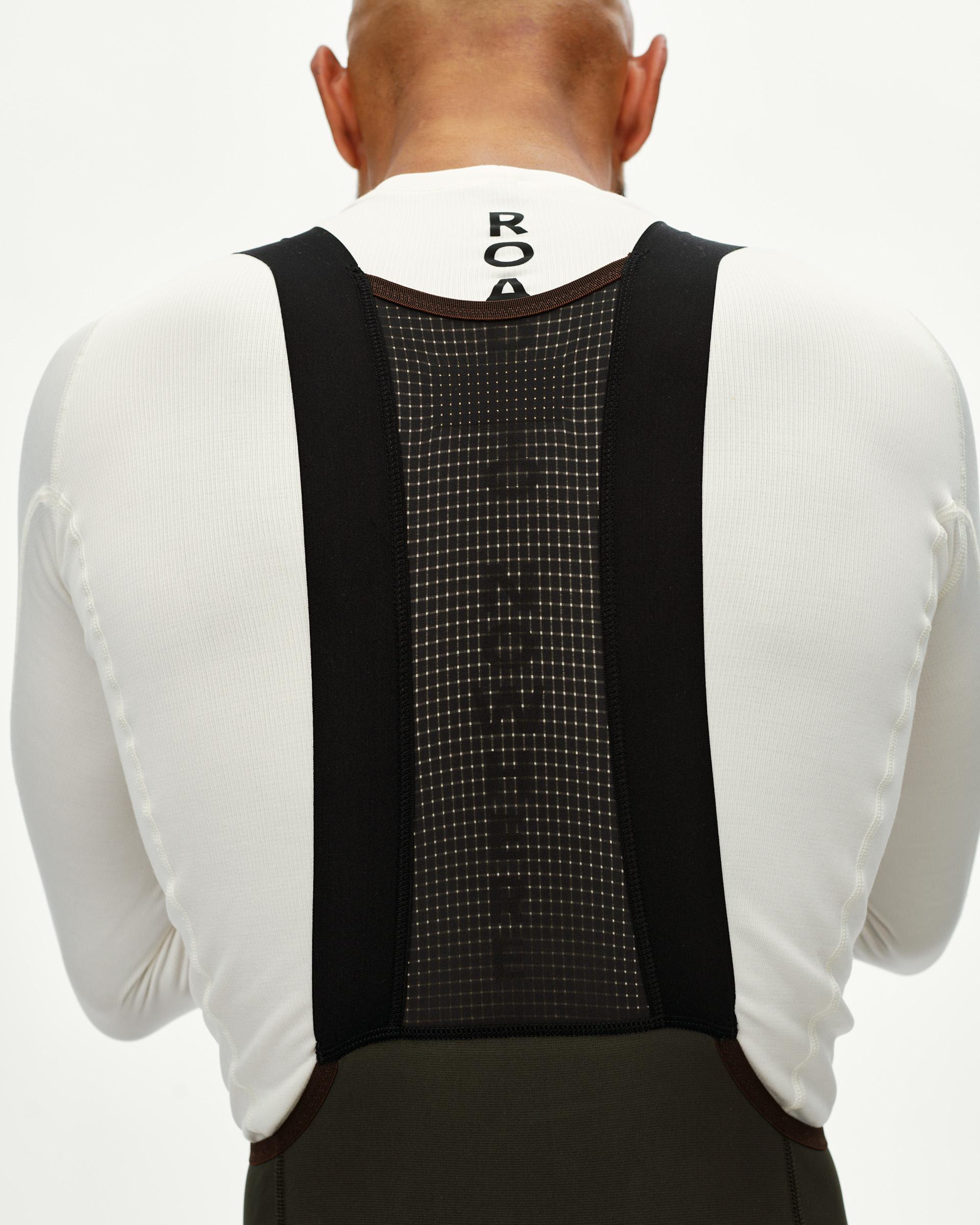 Dark Olive Escapism Long Cargo cycling bibs on model, rear view with mesh bib panel