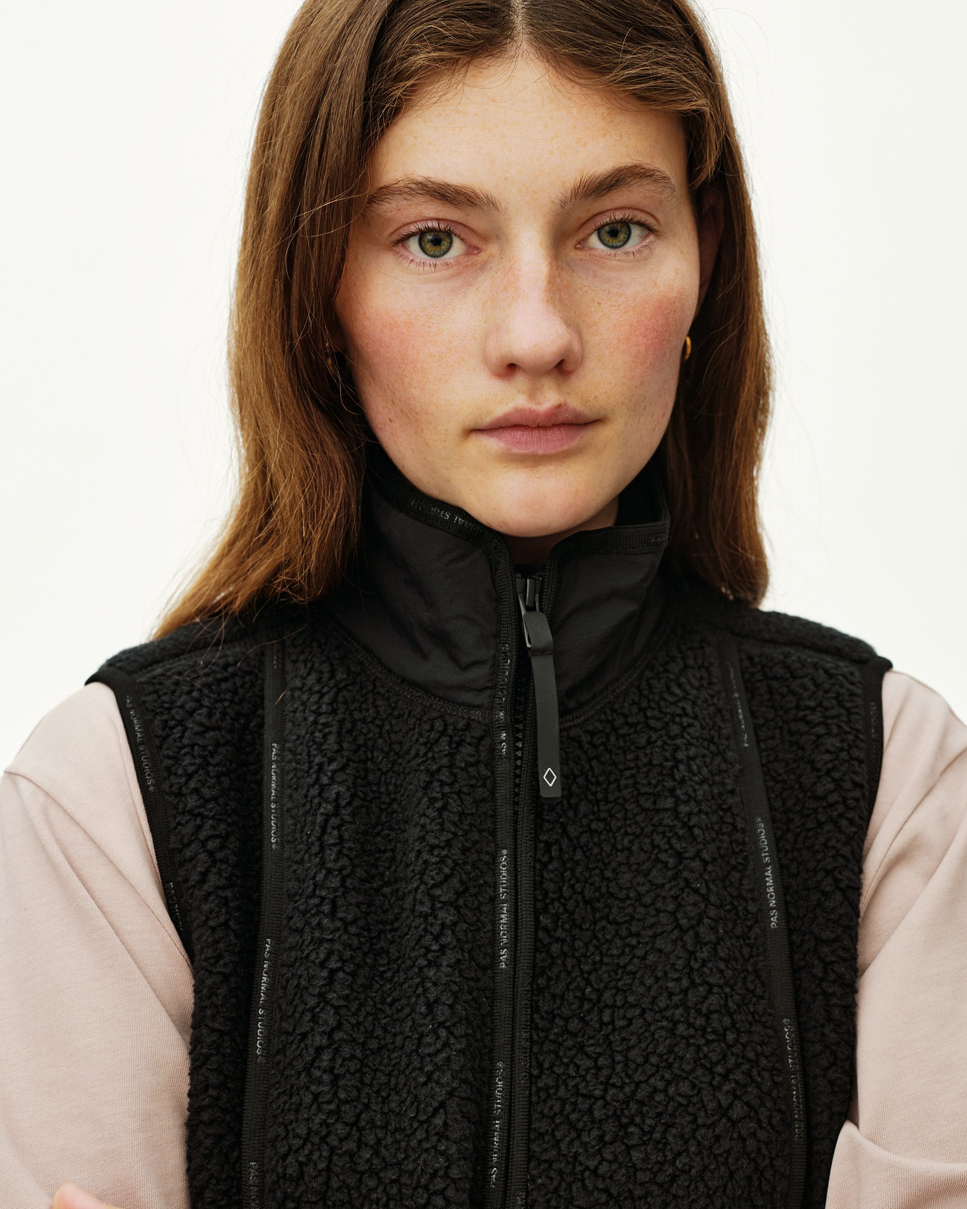 Black Off-Race Pile Fleece Vest on model, front close-up with sherpa texture and logo zip trim