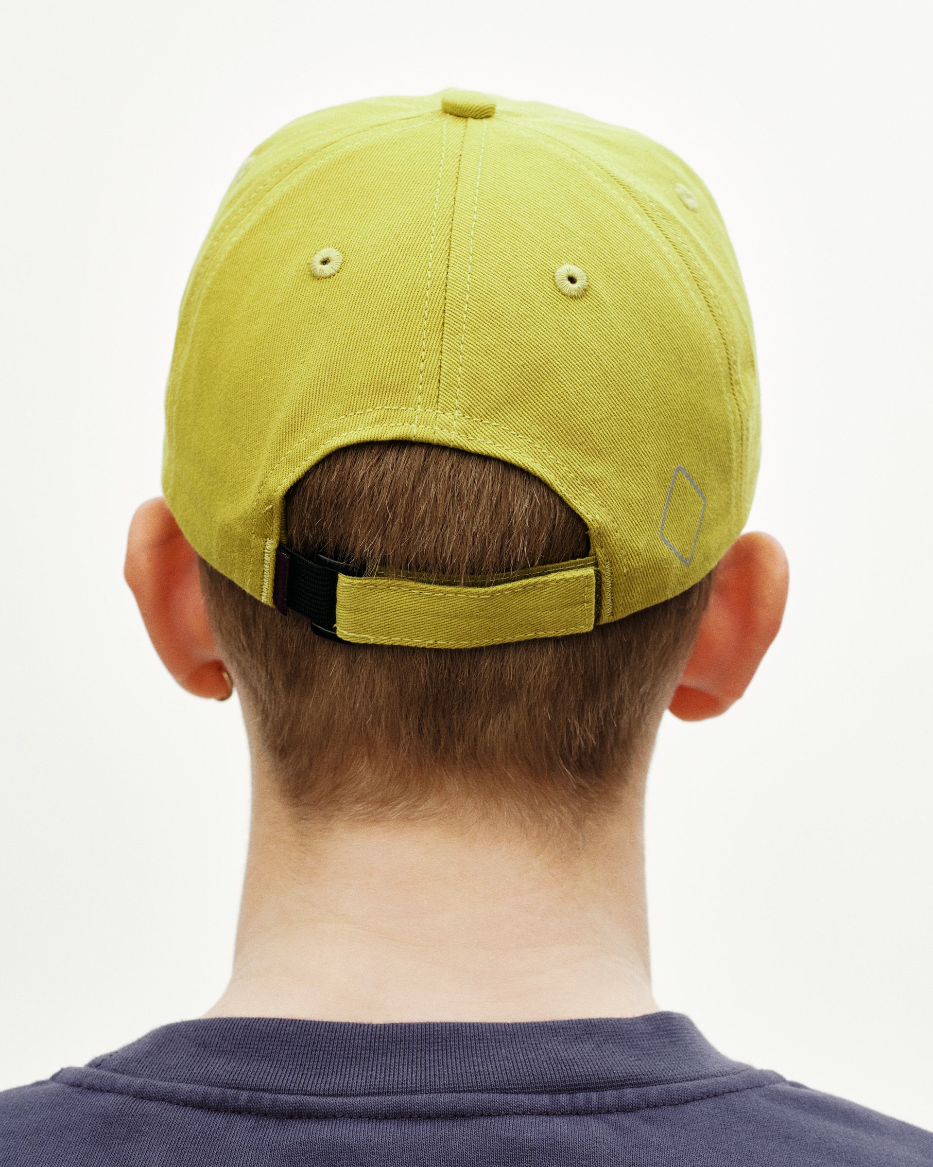 Green Off-Race Cotton cap, rear view on model with adjustable strap