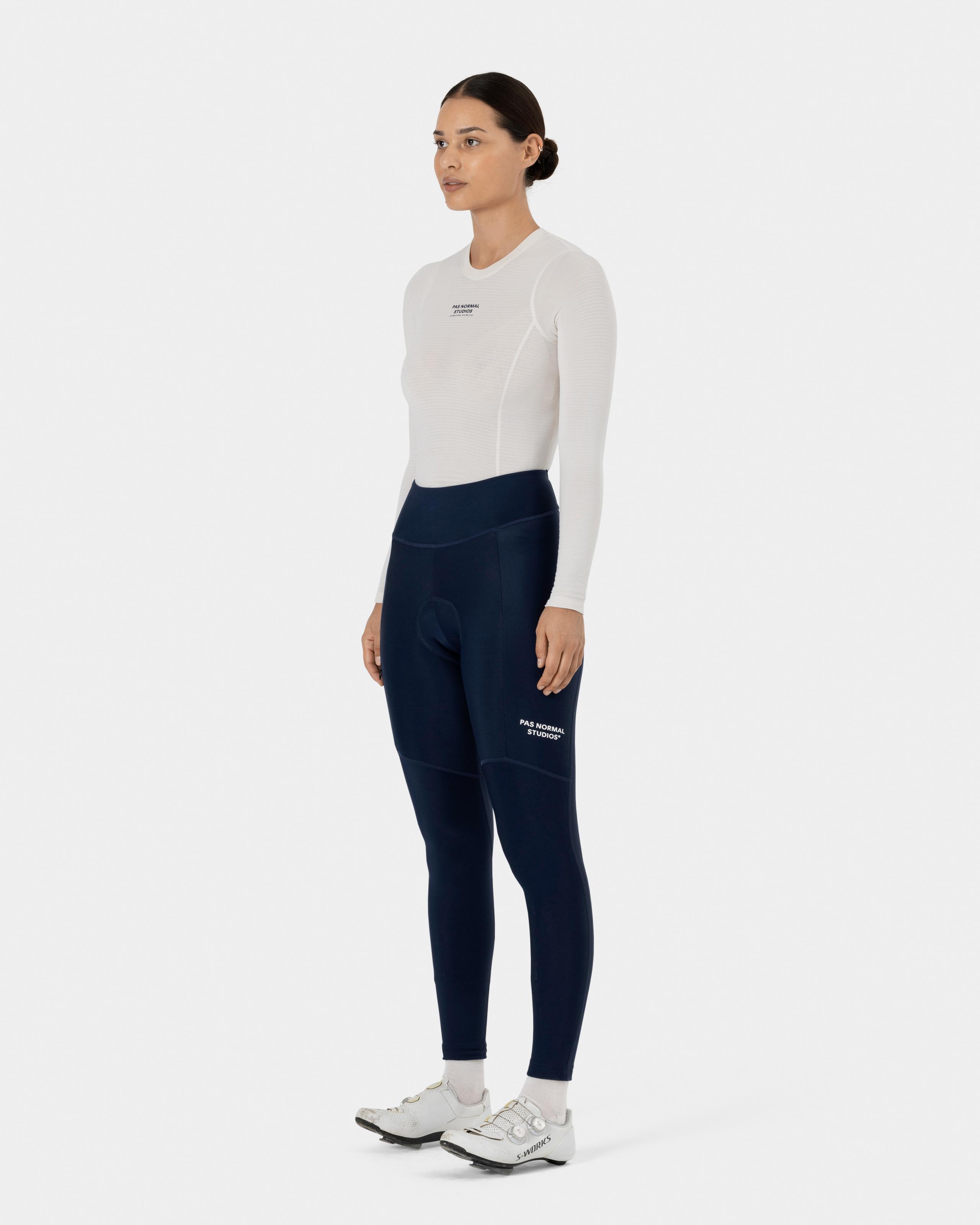 Navy Essential thermal long tights on model, side view with high waistband and white leg branding
