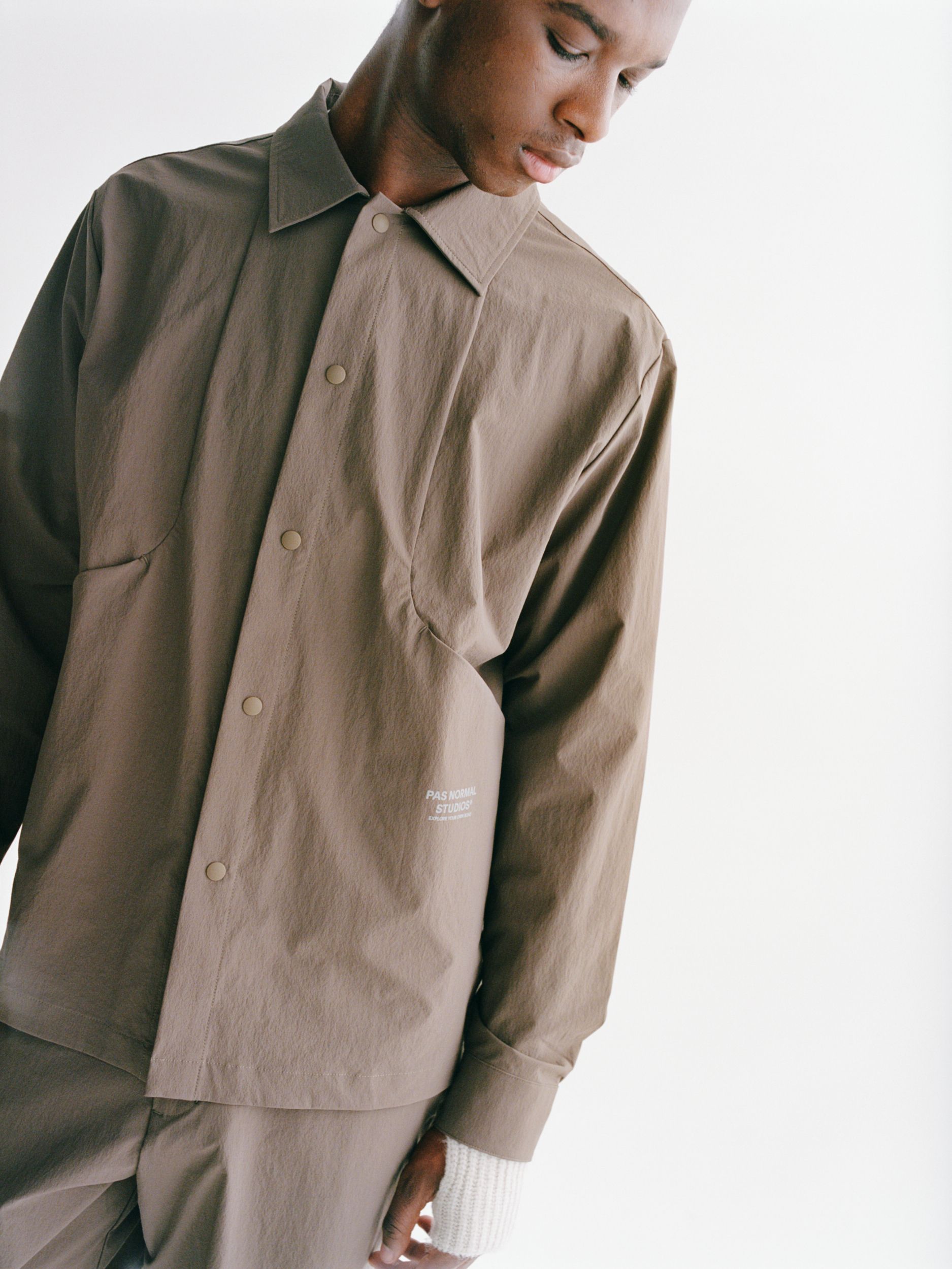 Ash Brown Off-Race Tech Overshirt on model with olive jacket layered over shoulder